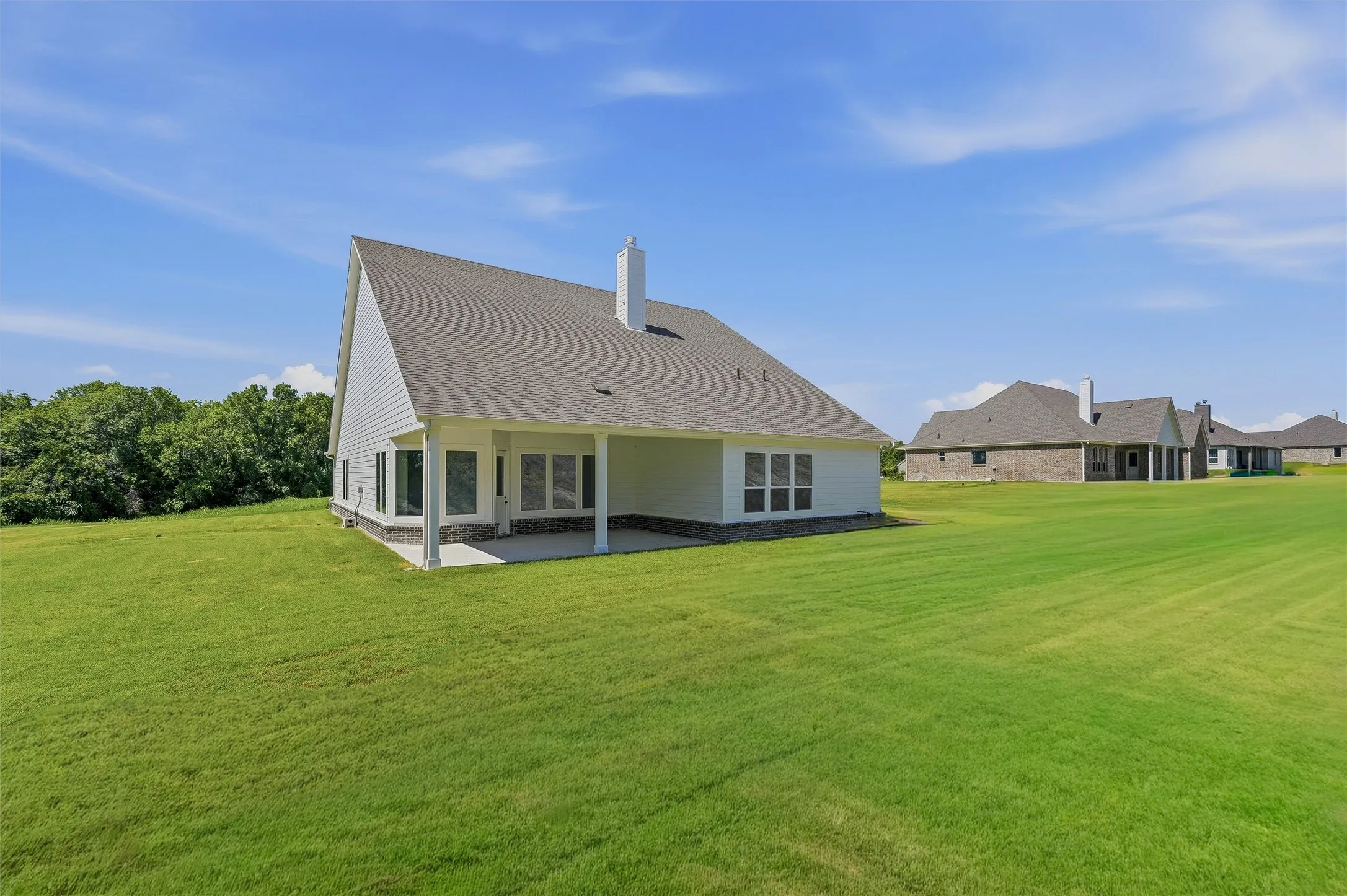 Expansive rear yard with a covered patio