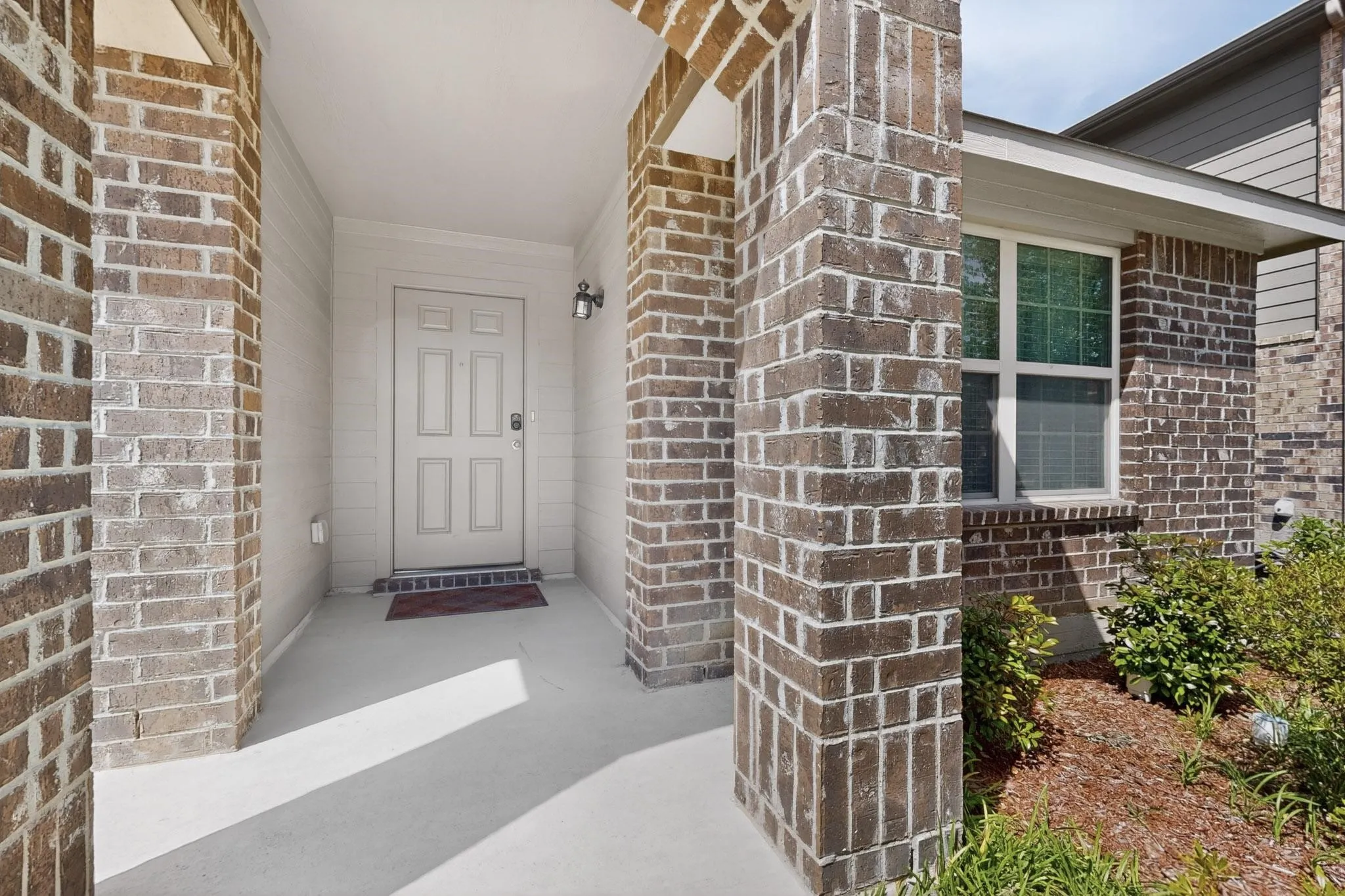View of exterior entry with brick siding