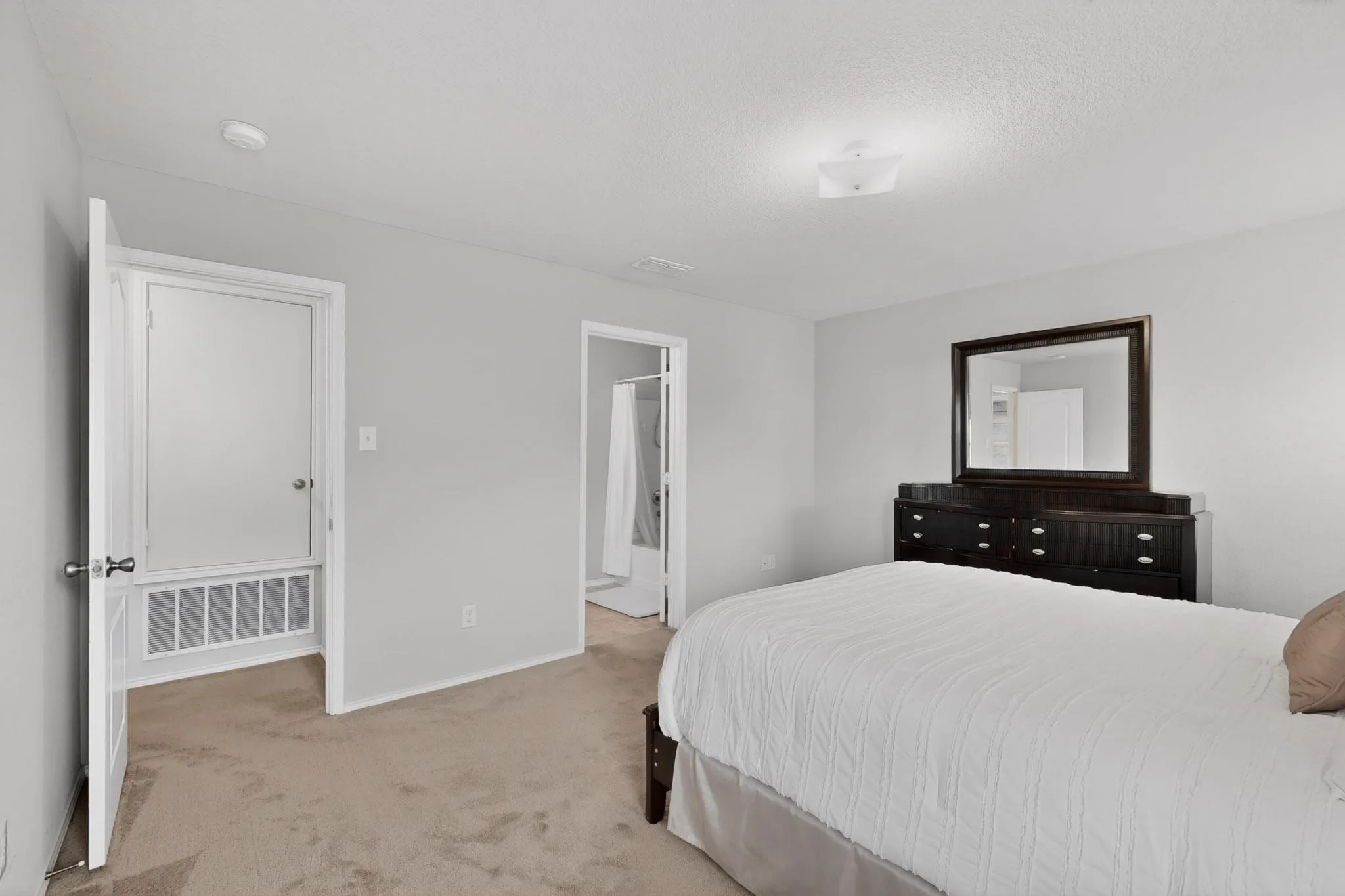 Bedroom with light carpet and baseboards