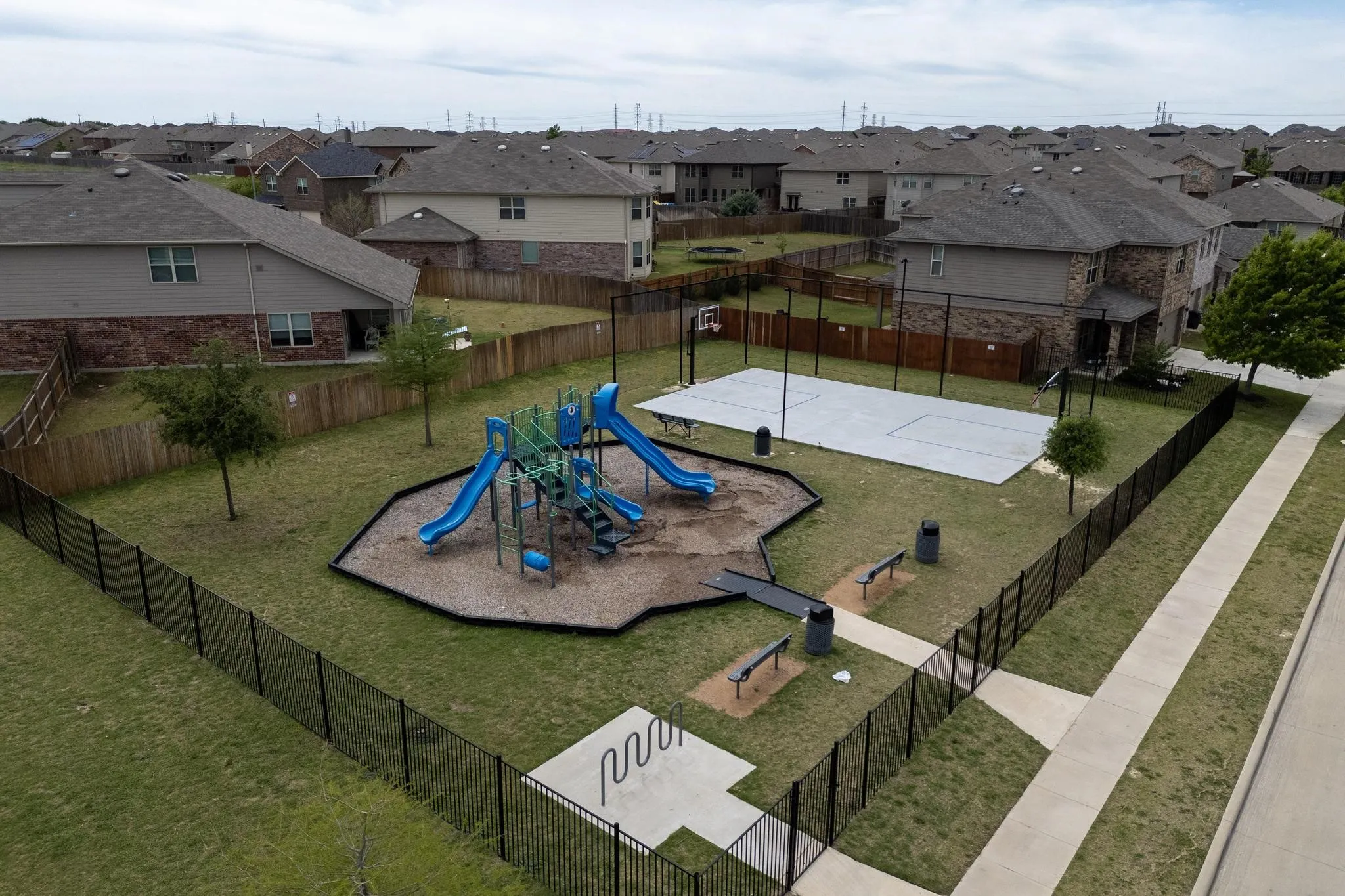 Community play area with community basketball court and a residential view