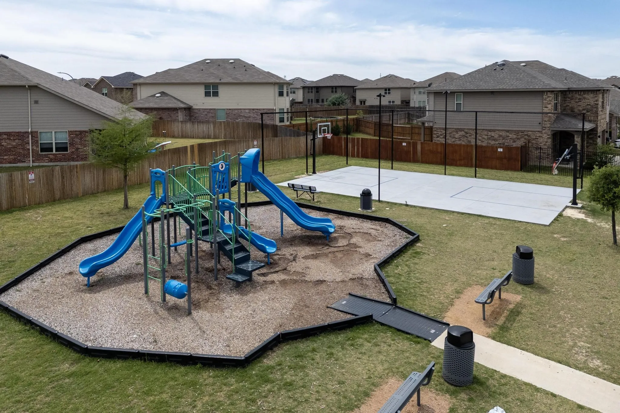 View of jungle gym with a residential view and community basketball court
