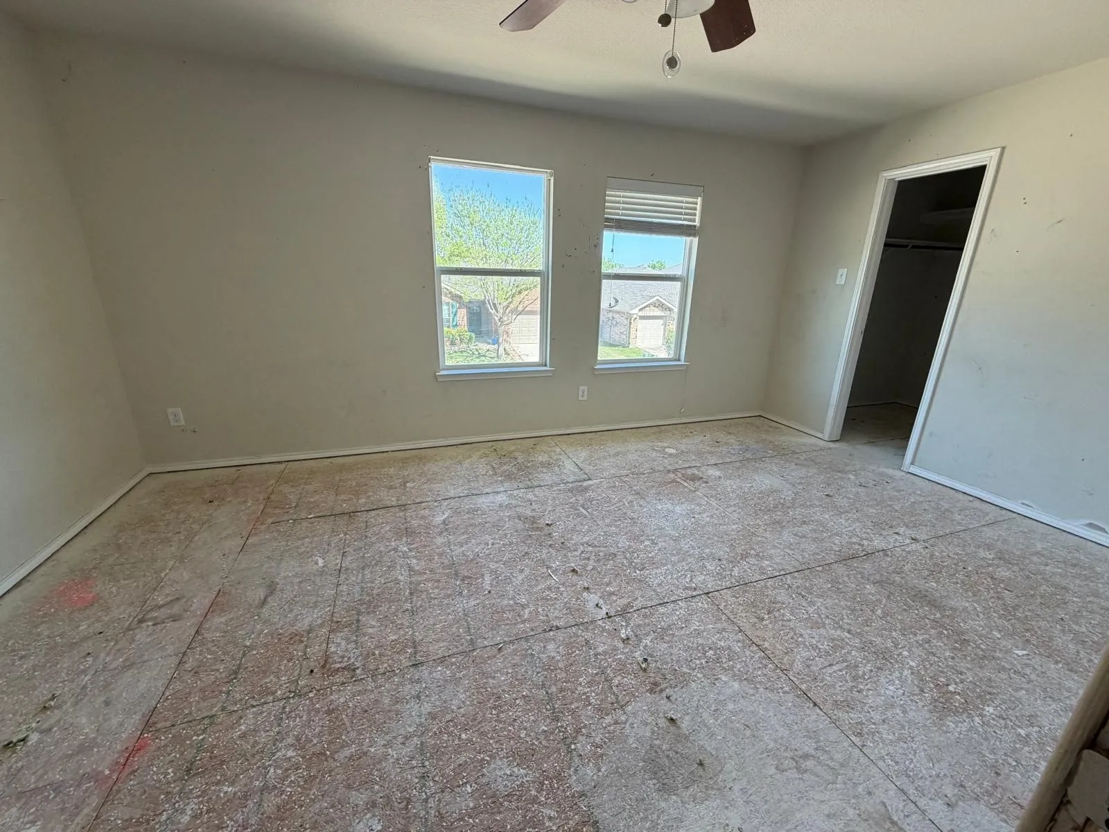 Unfurnished bedroom featuring a walk in closet and ceiling fan