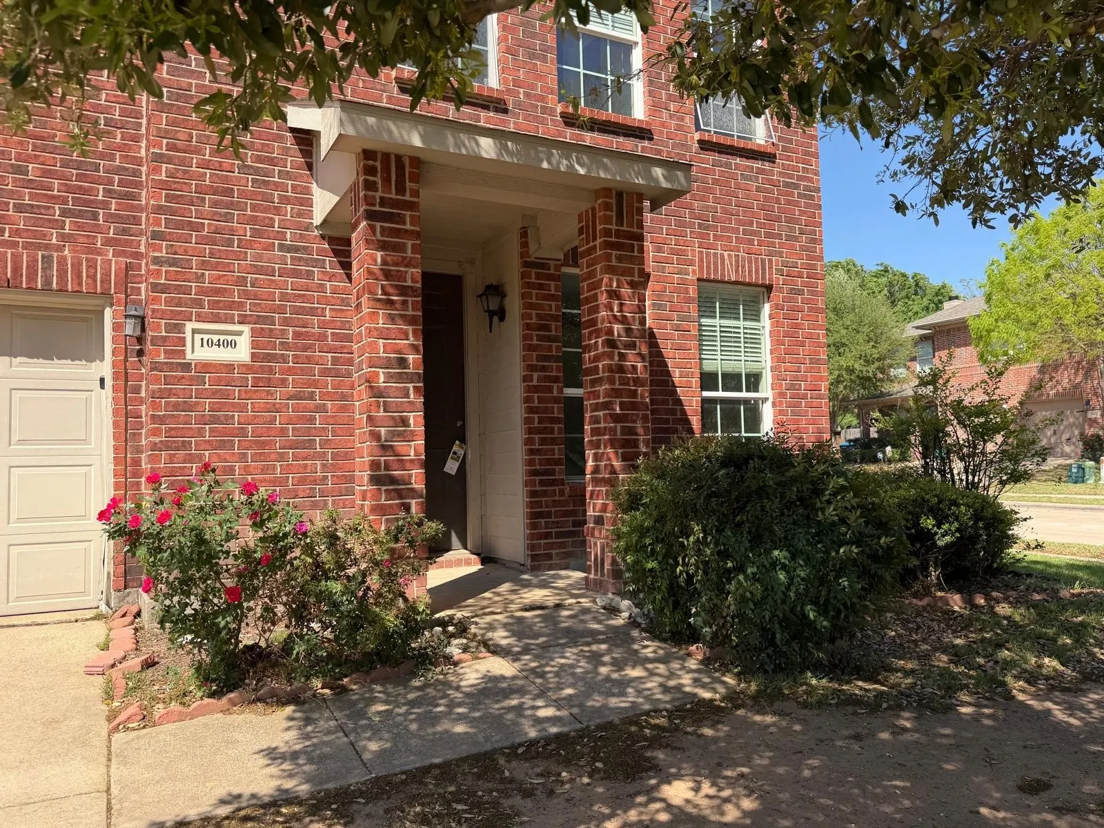 Entrance to property with brick siding and a garage