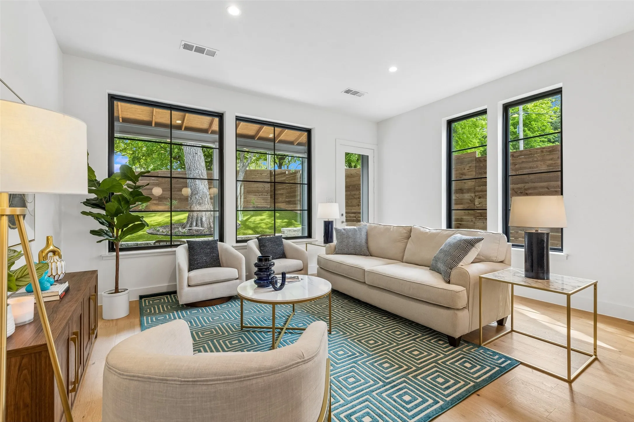 Living area featuring light wood-style flooring and recessed lighting