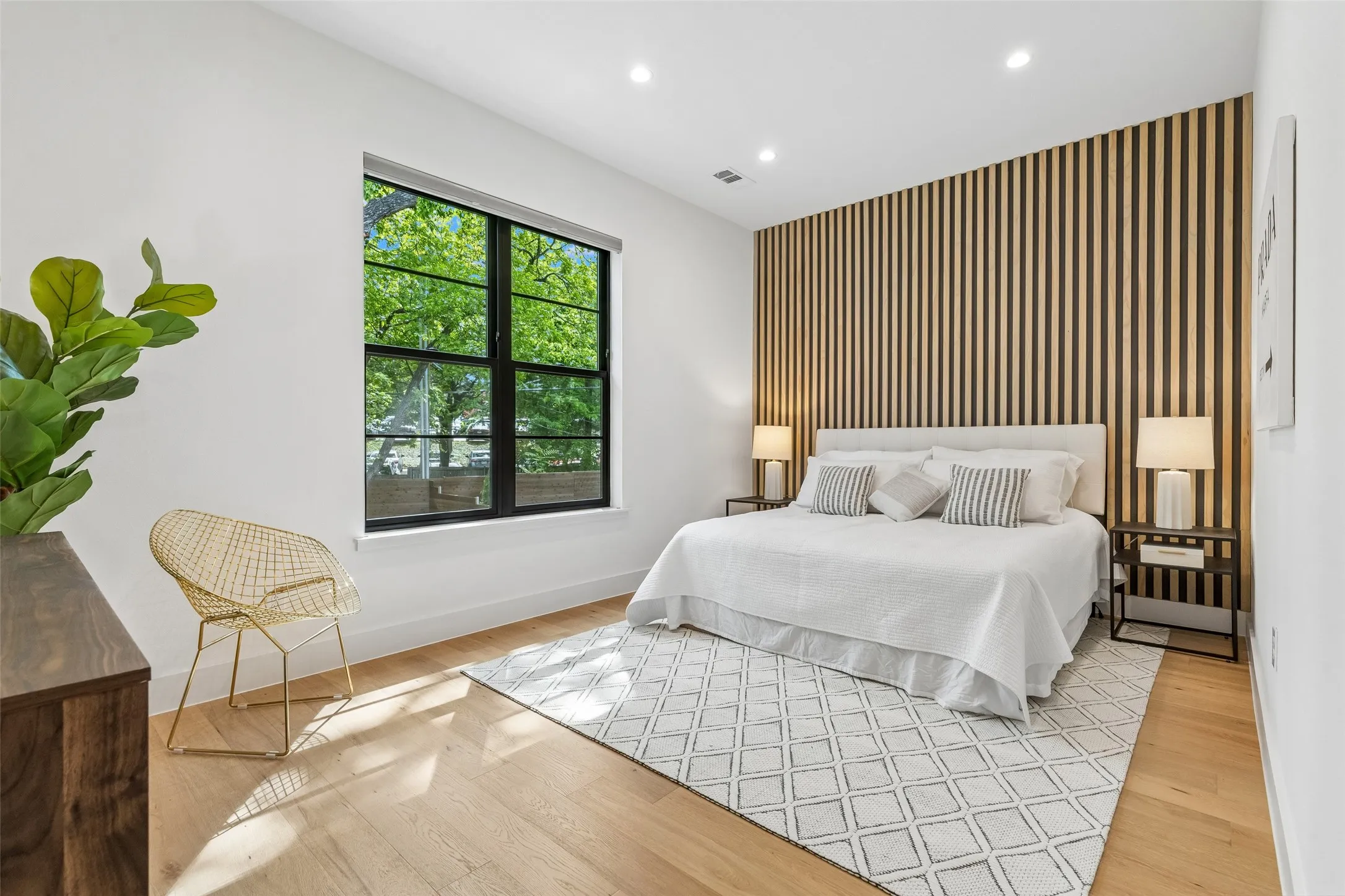 Bedroom featuring an accent wall, recessed lighting, light wood finished floors, and wallpapered walls