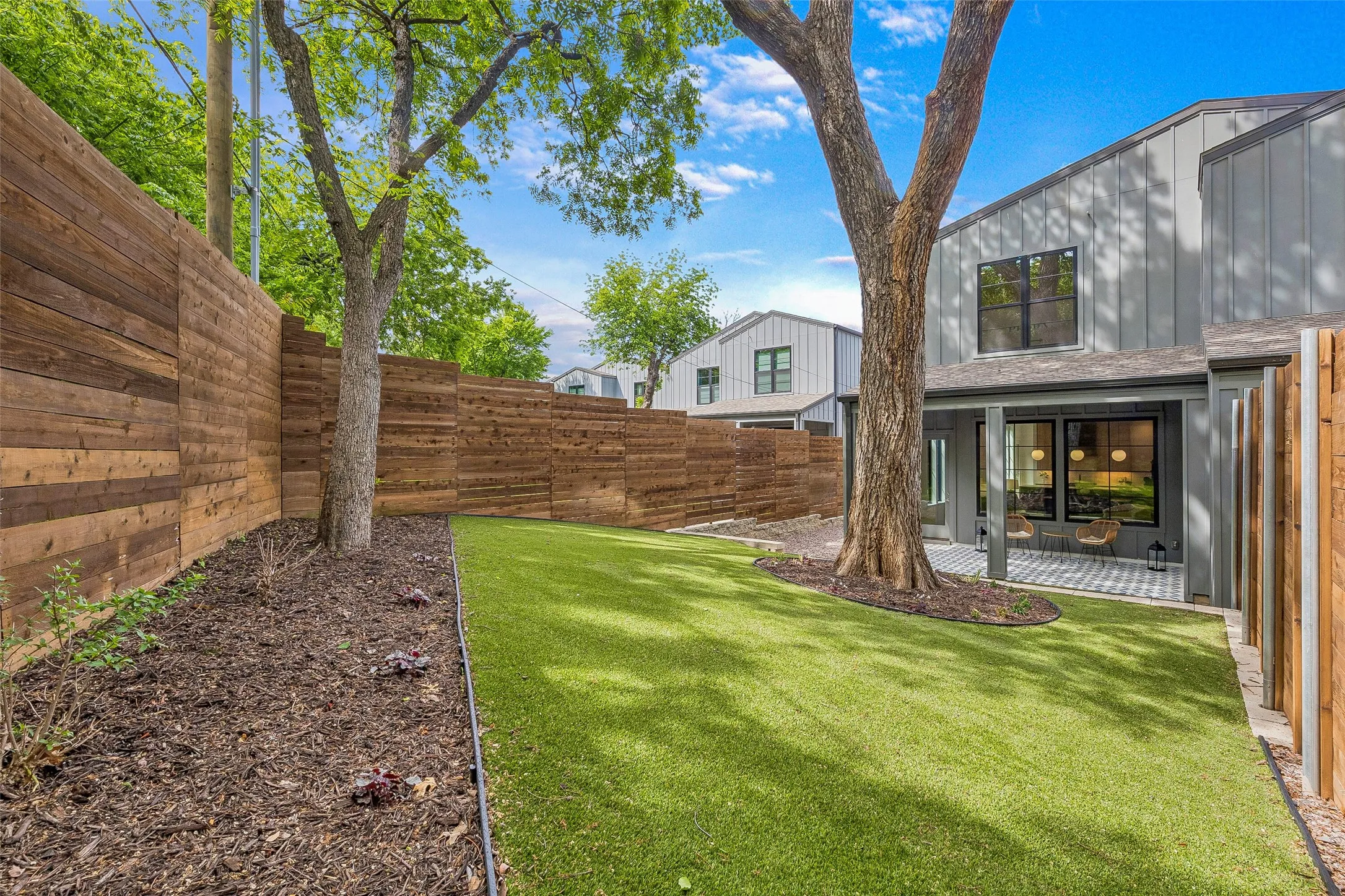 Fenced backyard with a patio area
