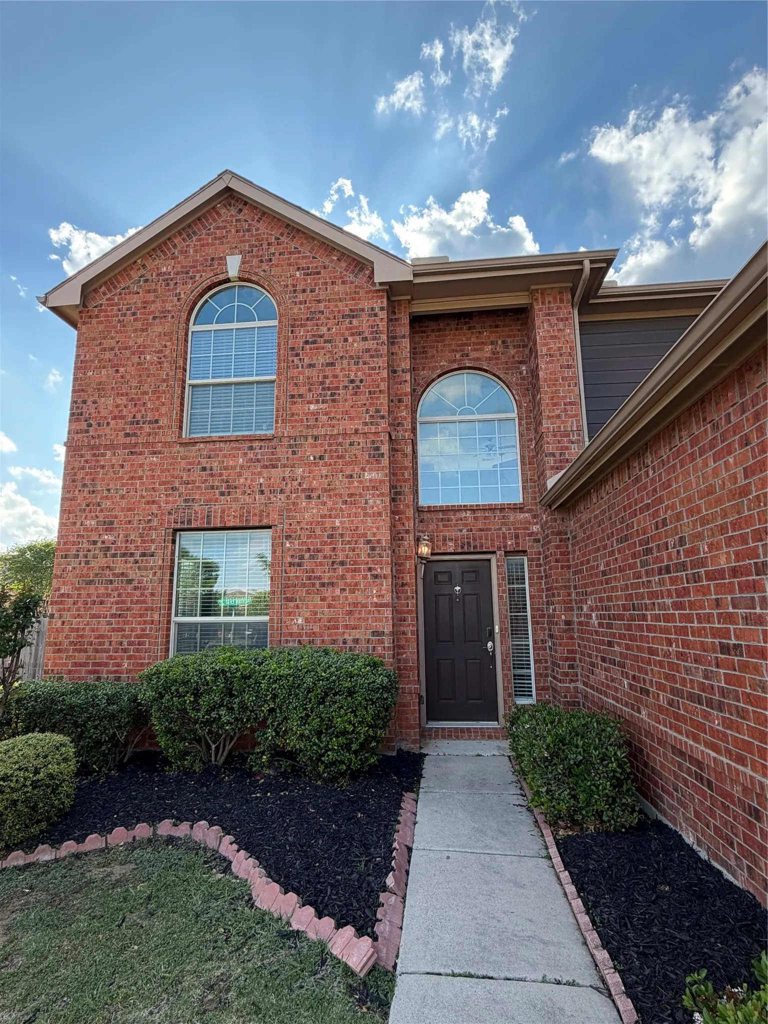 Doorway to property featuring brick siding
