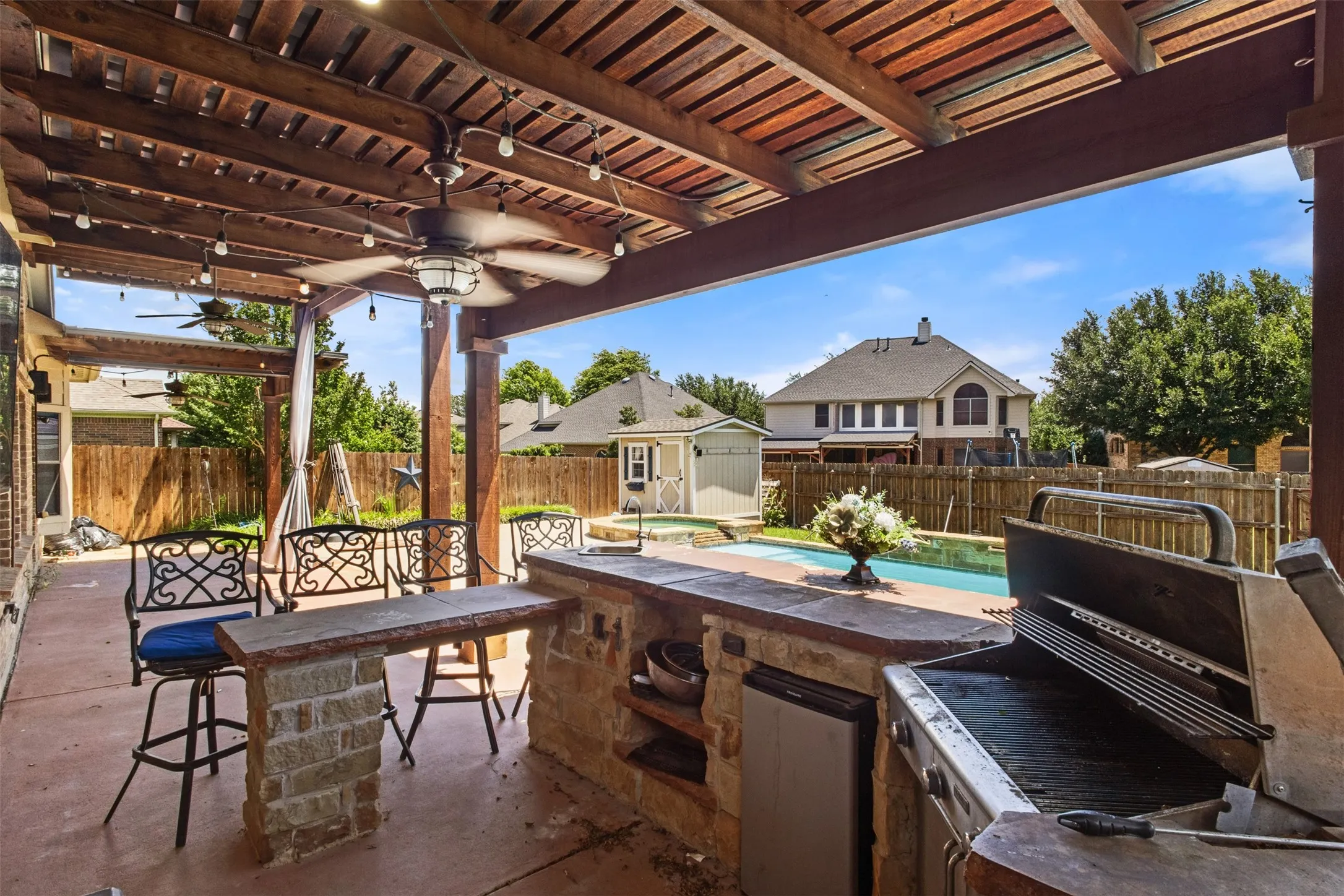 20ft covered patio featuring an outdoor kitchen with built-in grill and beverage refrigerator