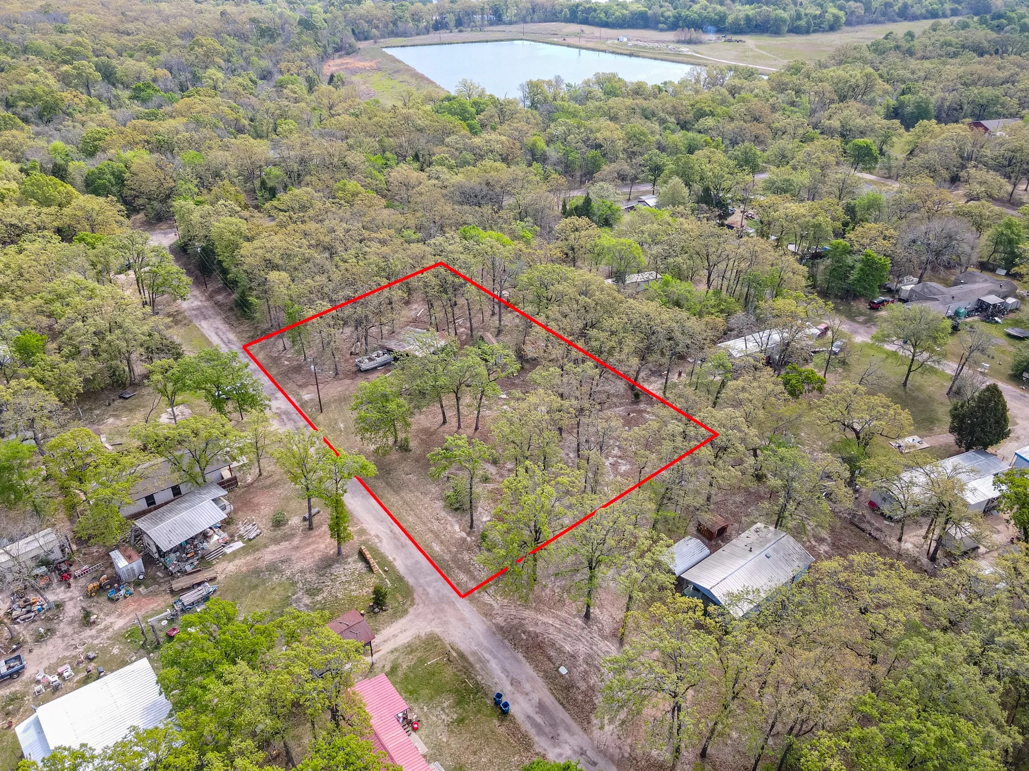 Aerial overview of property's location with property boundaries highlighted and a large body of water