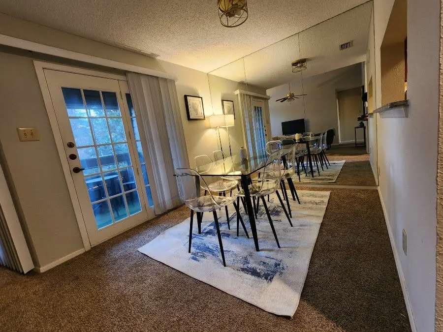 Dining space featuring carpet and a textured ceiling
