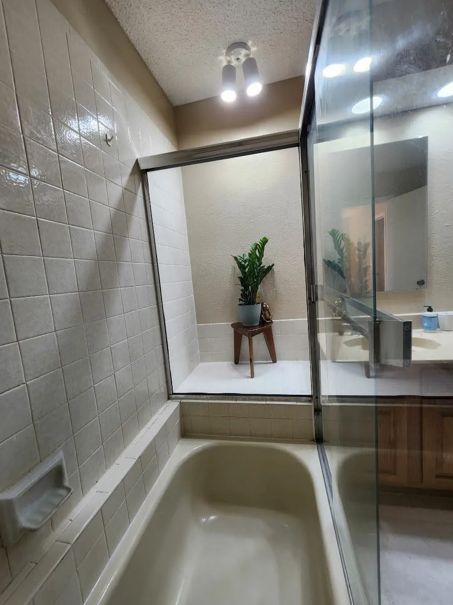 Bathroom with a garden tub and a textured ceiling