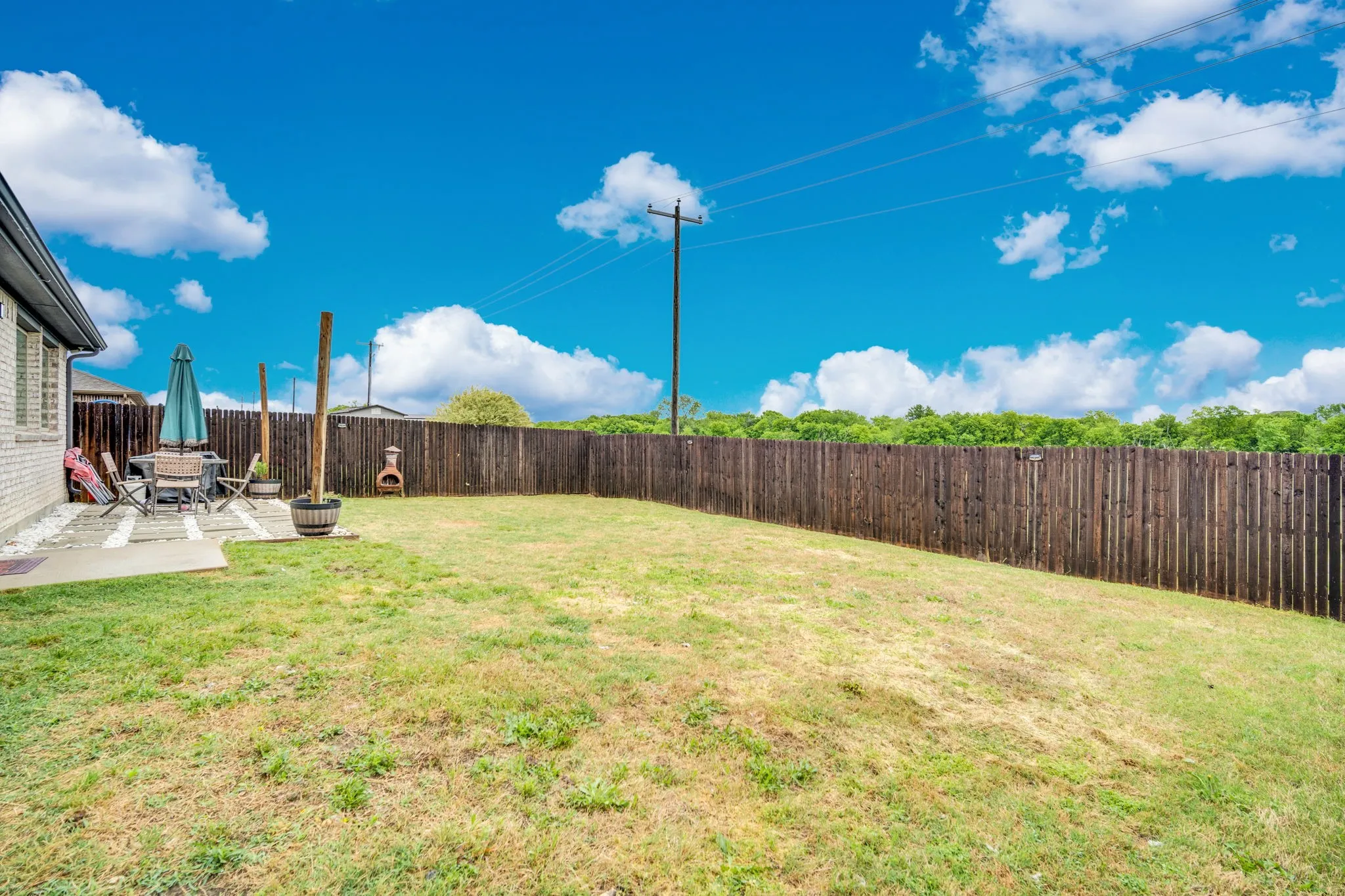 Fenced backyard with a patio