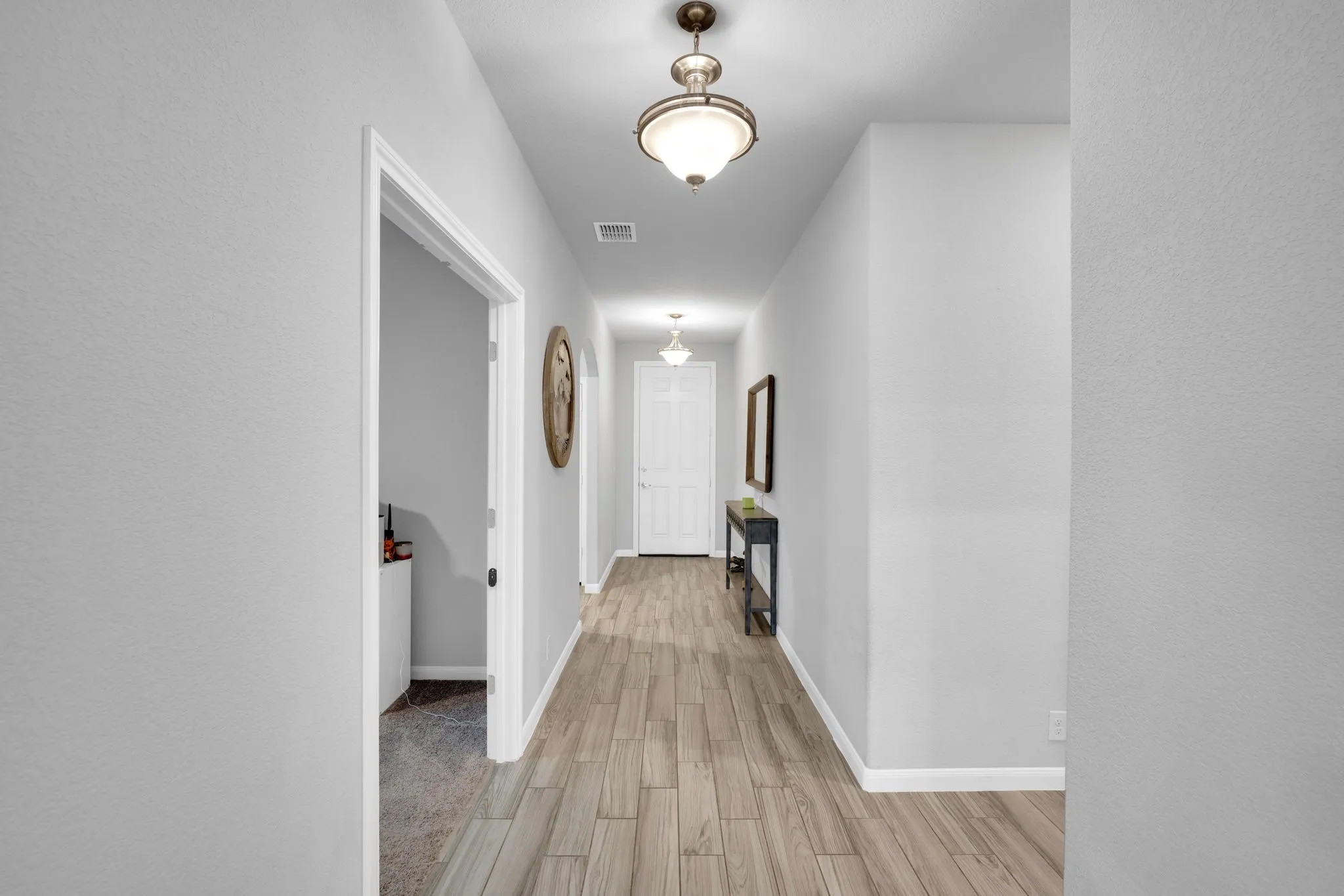 Corridor with light wood-style floors