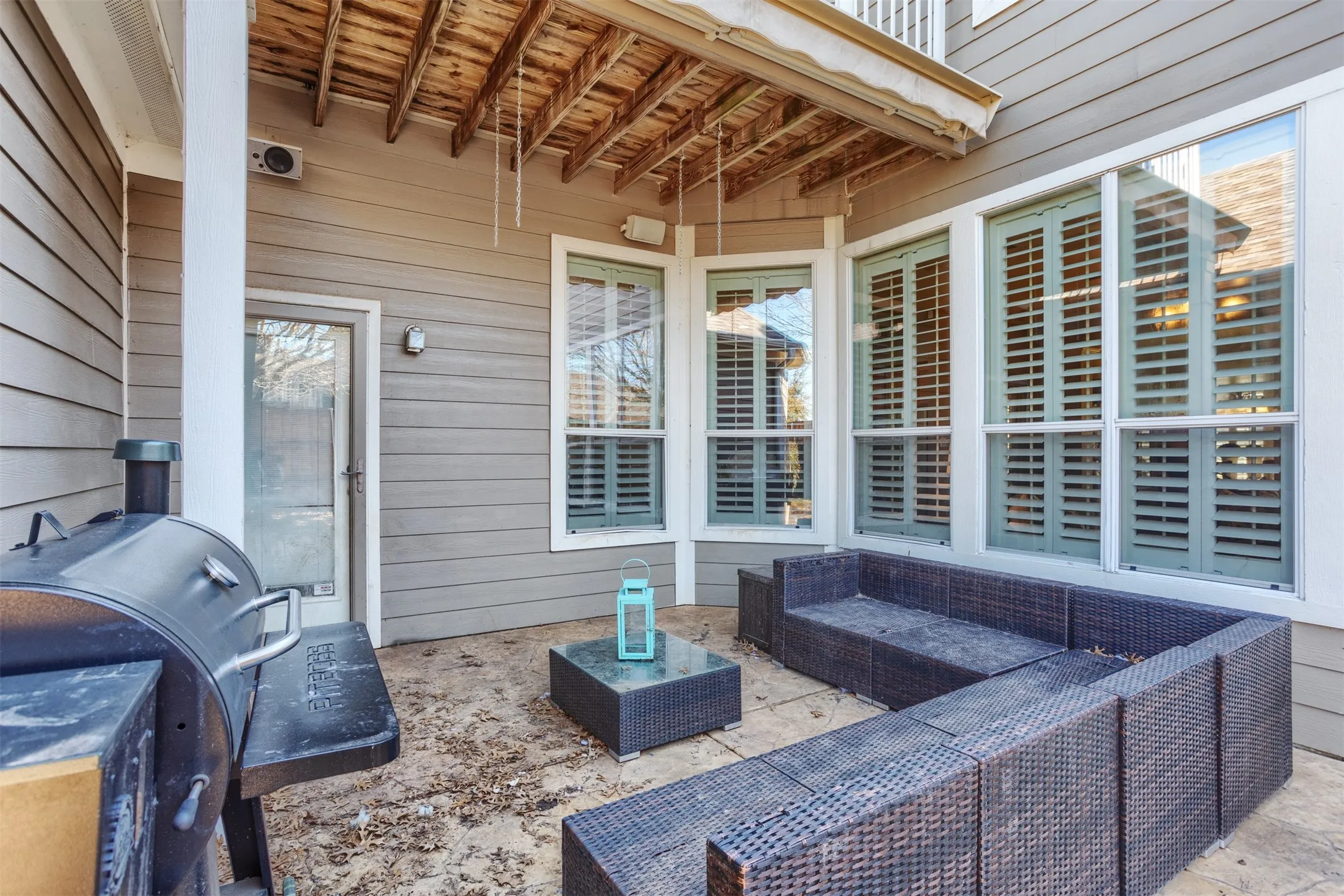 Fantastic covered porch with an awning that extends for more shade. That is so cool! Time for a backyard barbecue!
