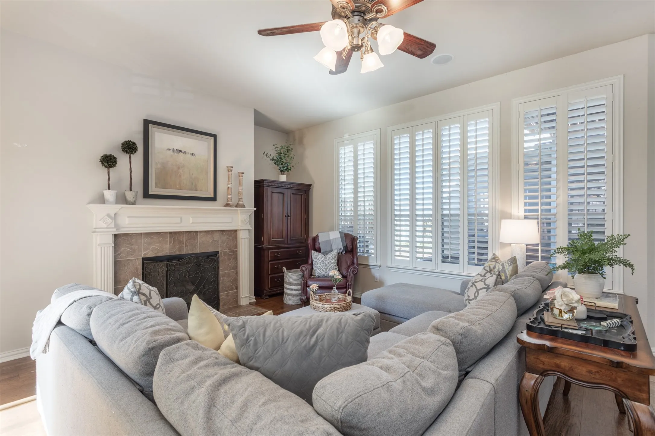 Cozy up by the fireplace and enjoy a good book. The open floor plan is ideal for entertaining and leads out to the spectacular backyard. Look at those stunning shutters!