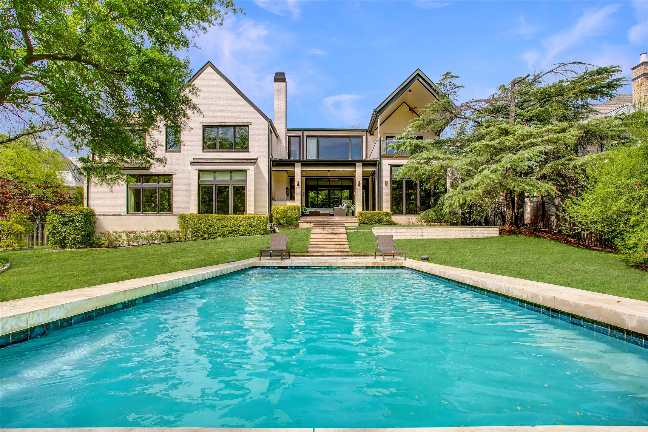 Gorgeous backyard oasis with refreshing pool, covered patio with built-in grill, wood burning fireplace and electric screens.  Picturesque windows throughout the home with great views overlooking the backyard.