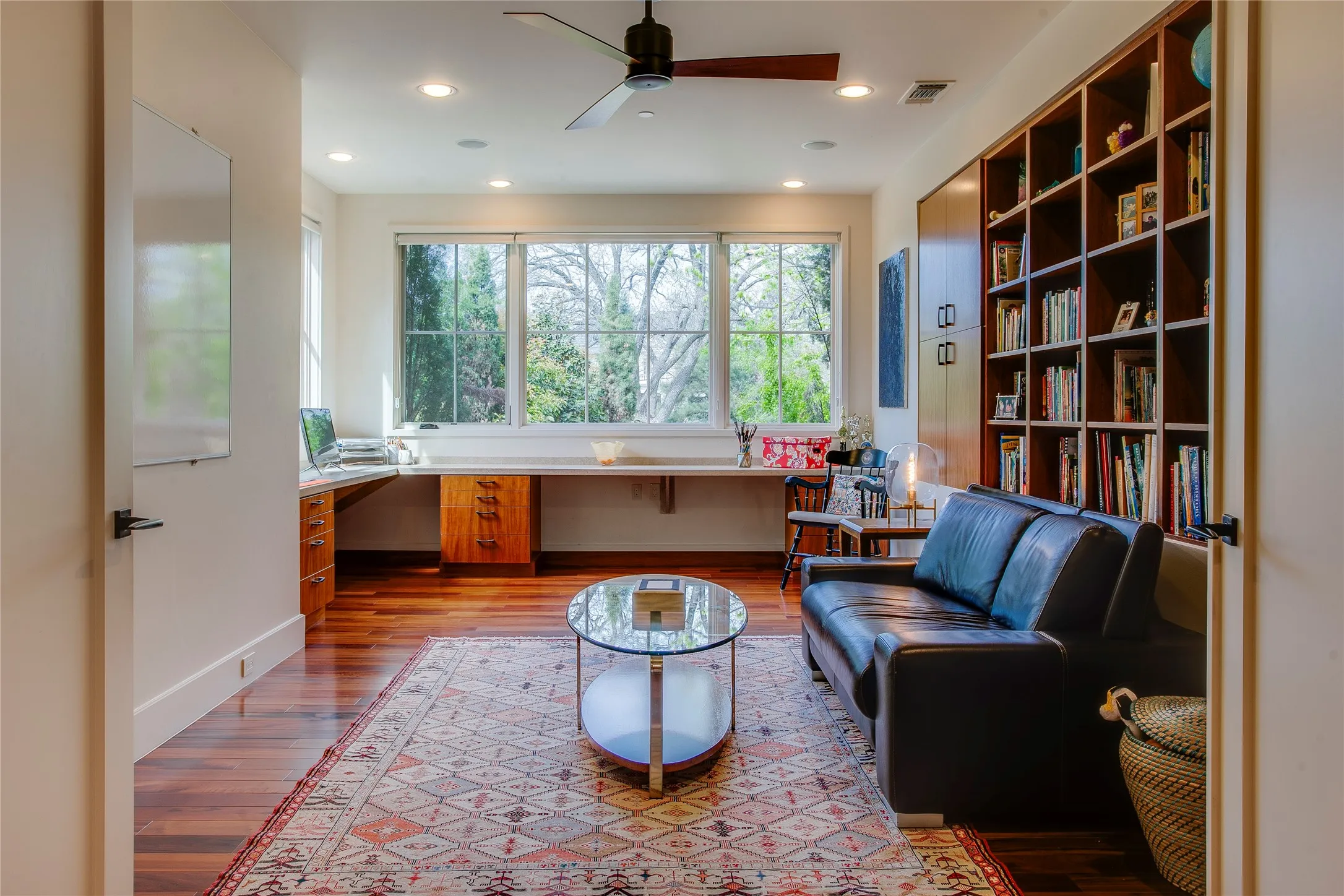 Built-in desks and bookshelves in the second story study overlook the beautiful front yard.