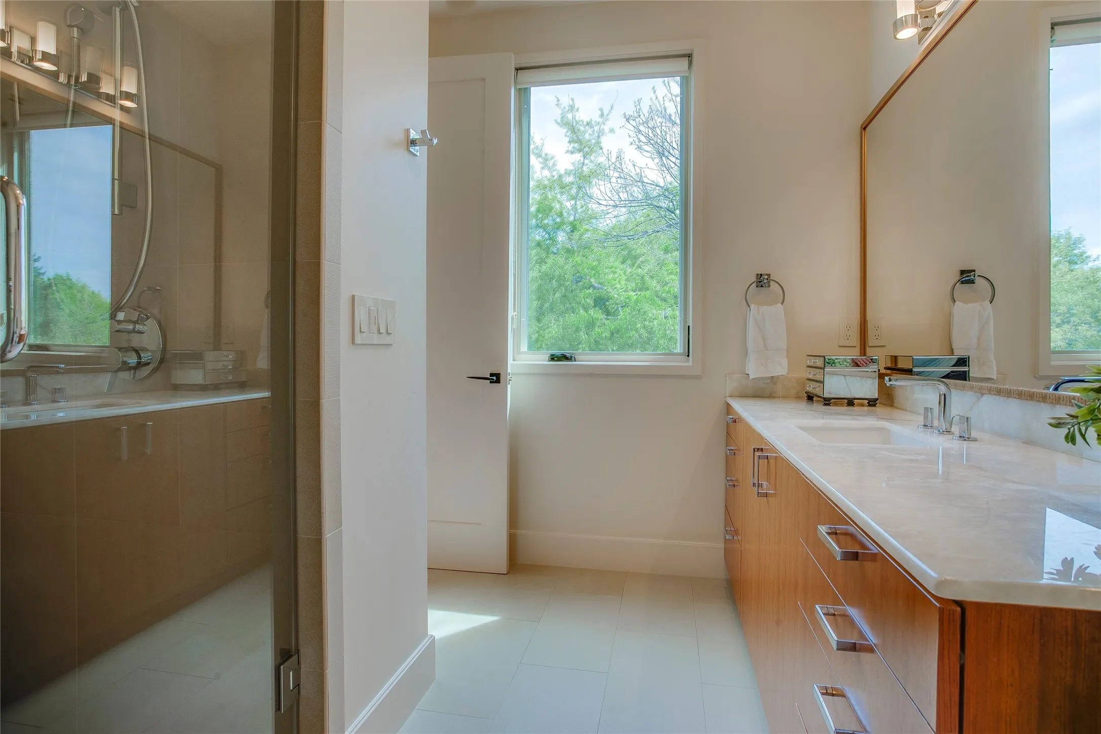 Guest suite bathroom with marble countertops and free standing large shower.