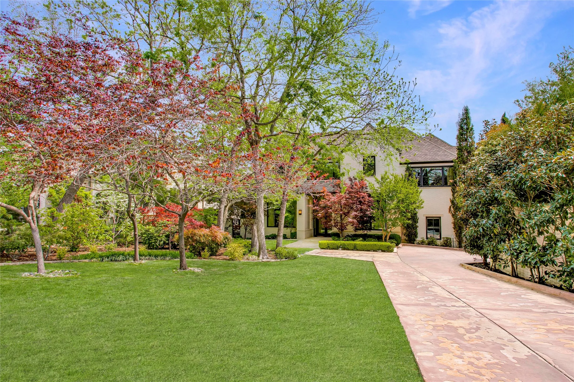 Lush greenspace, mature trees and stunning landscaping welcome you as you approach the home.