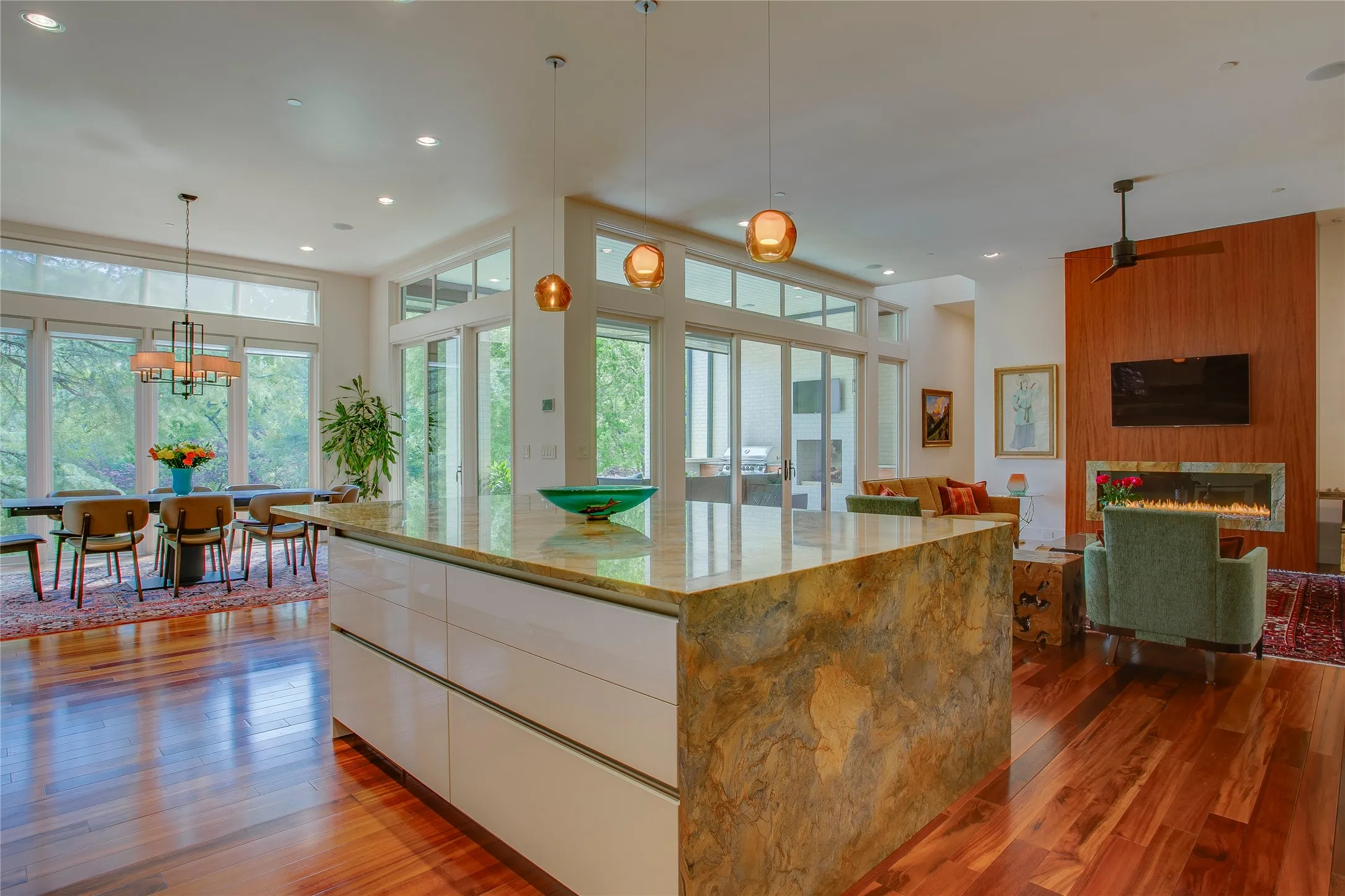 Entertainer's dream open concept great room with walls in of windows open to the backyard.