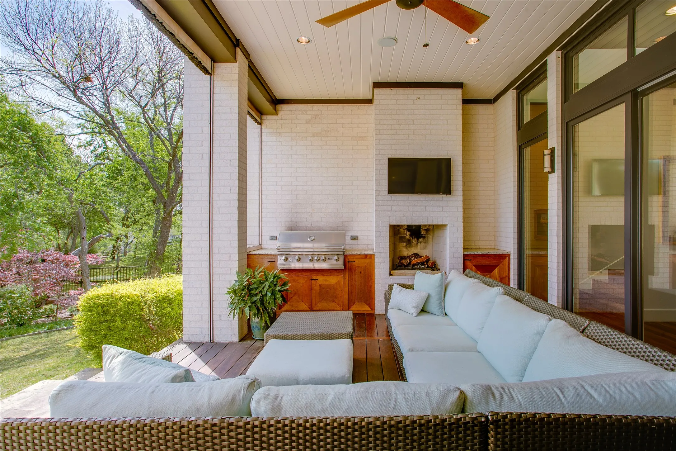 Covered patio with outdoor kitchen and fireplace. Great for summer or winter use with remote controlled screens.