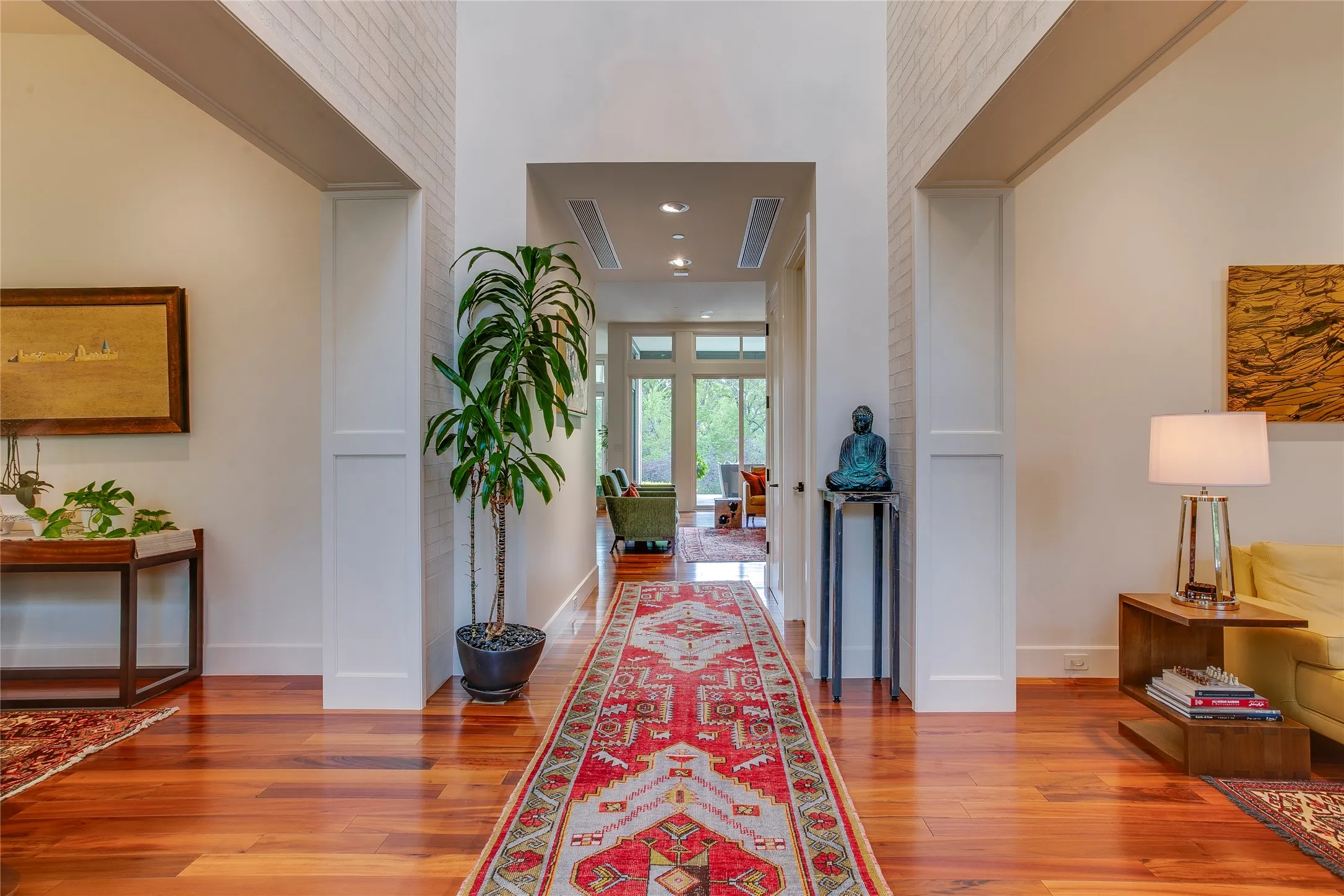 Grand two story entryway with views greeting you from the stunning backyard.