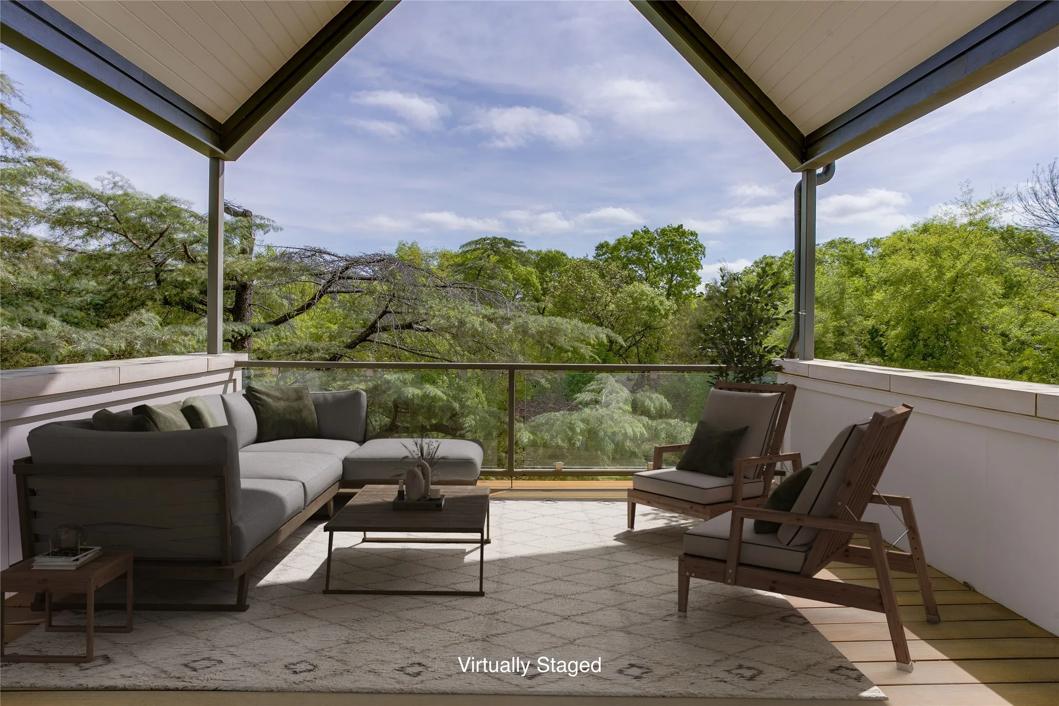 Blacony off primary suite overlooks the tree tops in the backyard.