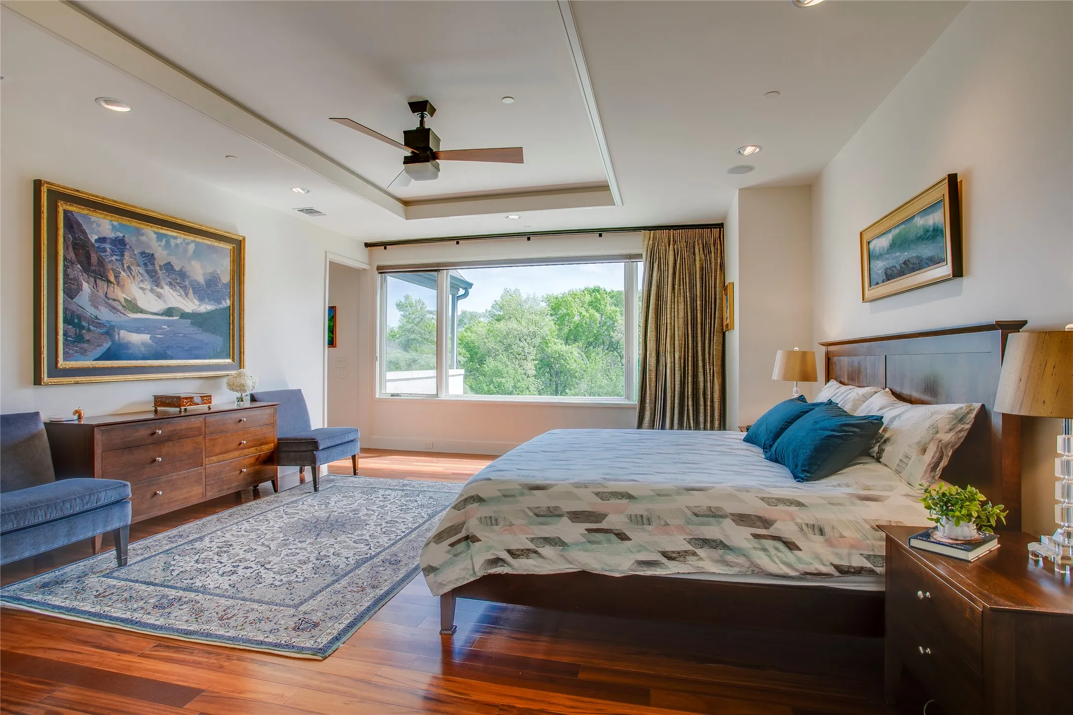 Primary suite with ensuite spa like bathroom, his/hers closet, sitting area and balcony overlooking the backyard.