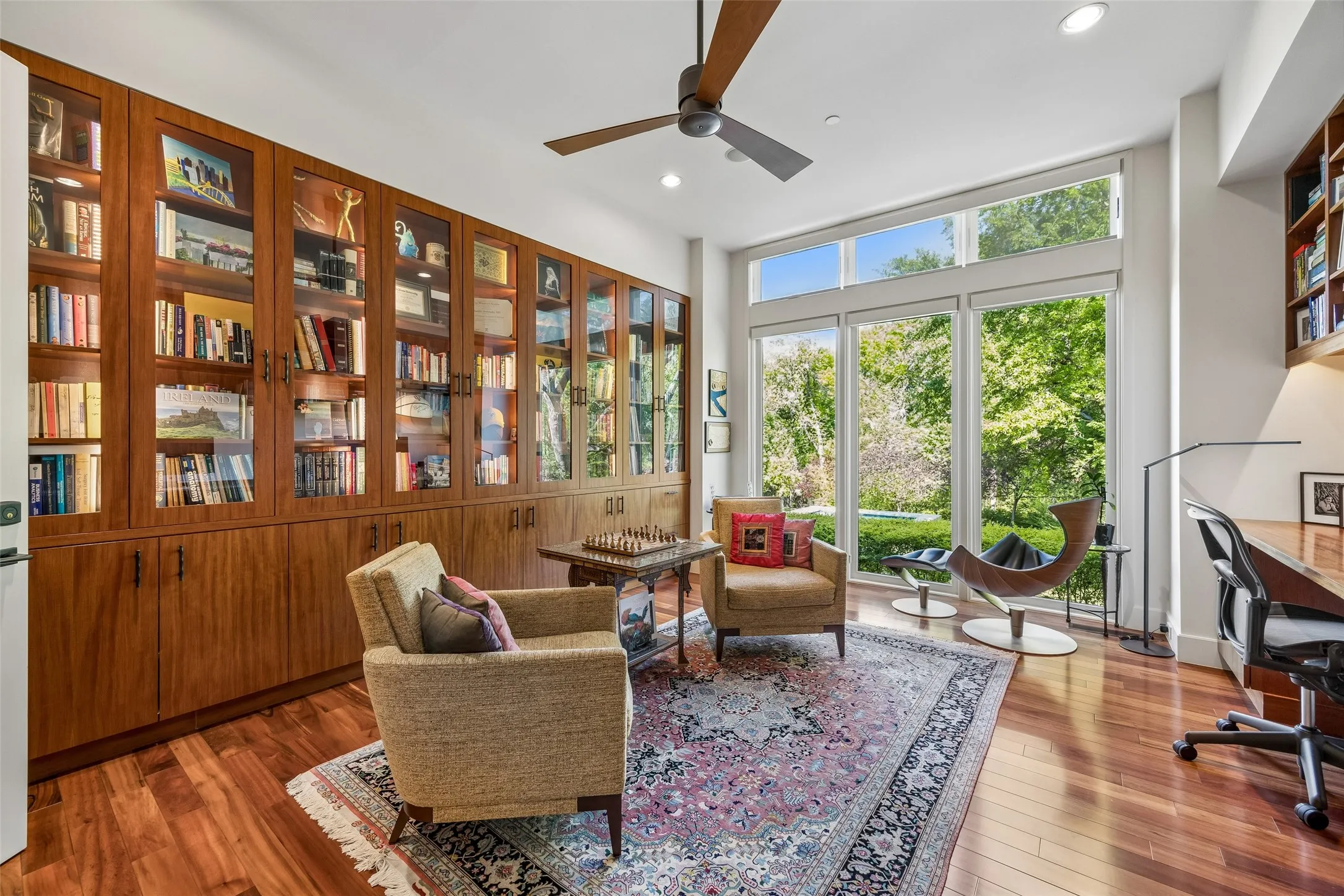 Downstairs study with built in cabinets and dual working stations overlooking lush backyard.