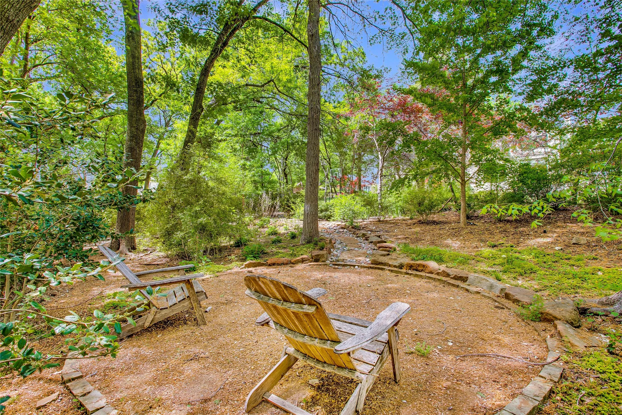 Backyard oasis with mature trees and views of the property.