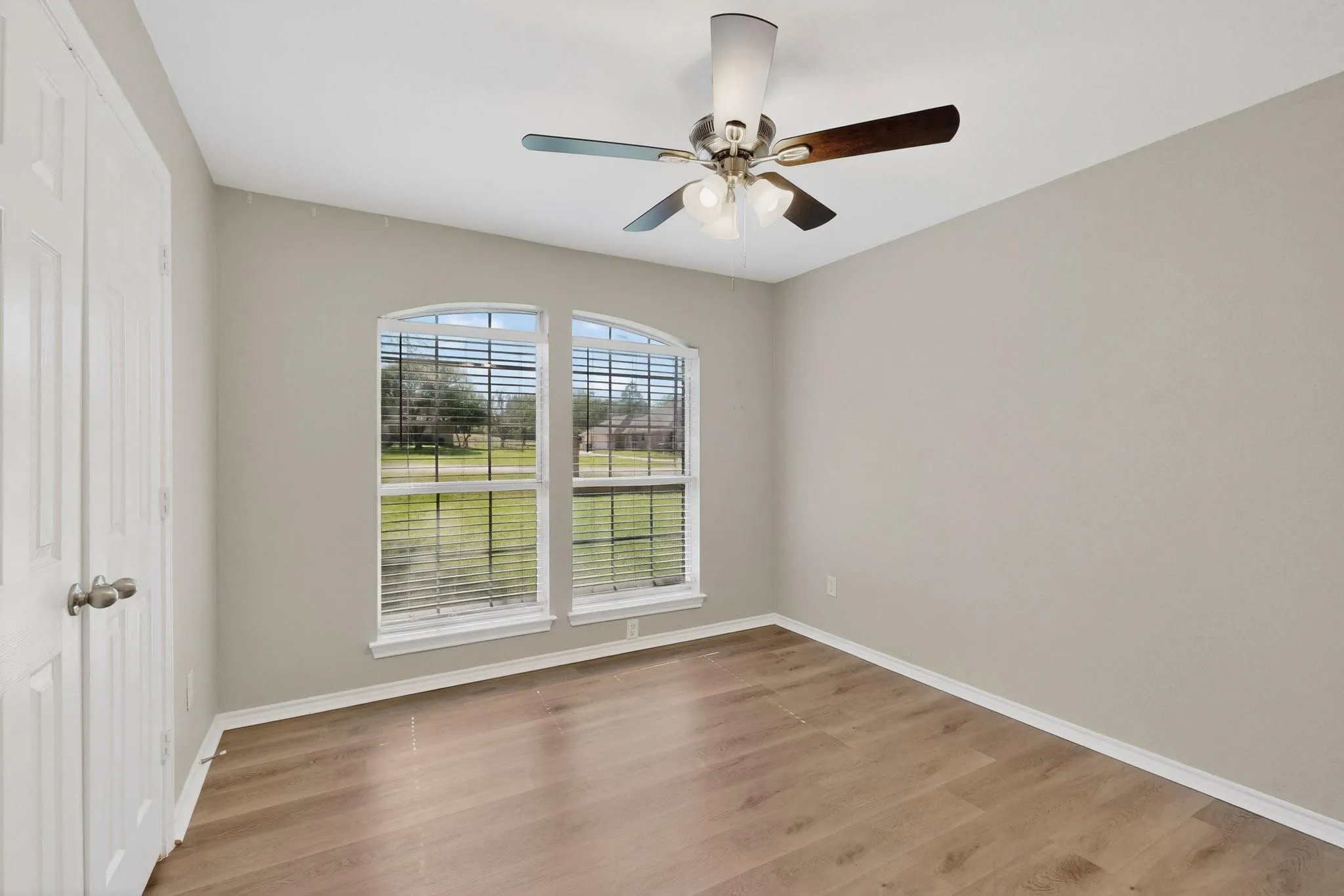 Unfurnished room with light wood finished floors and a ceiling fan