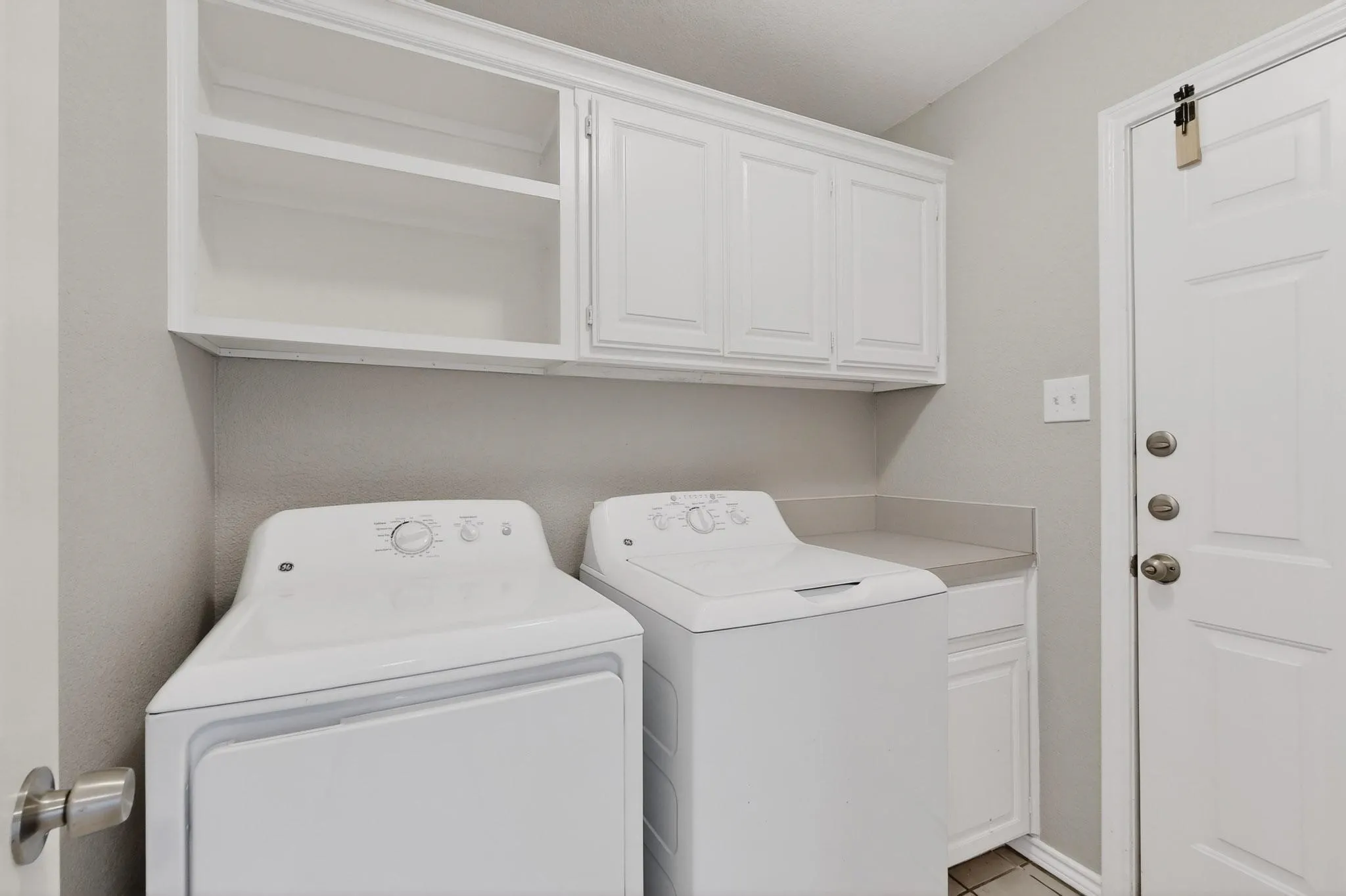 Laundry area featuring washer and dryer and cabinet space