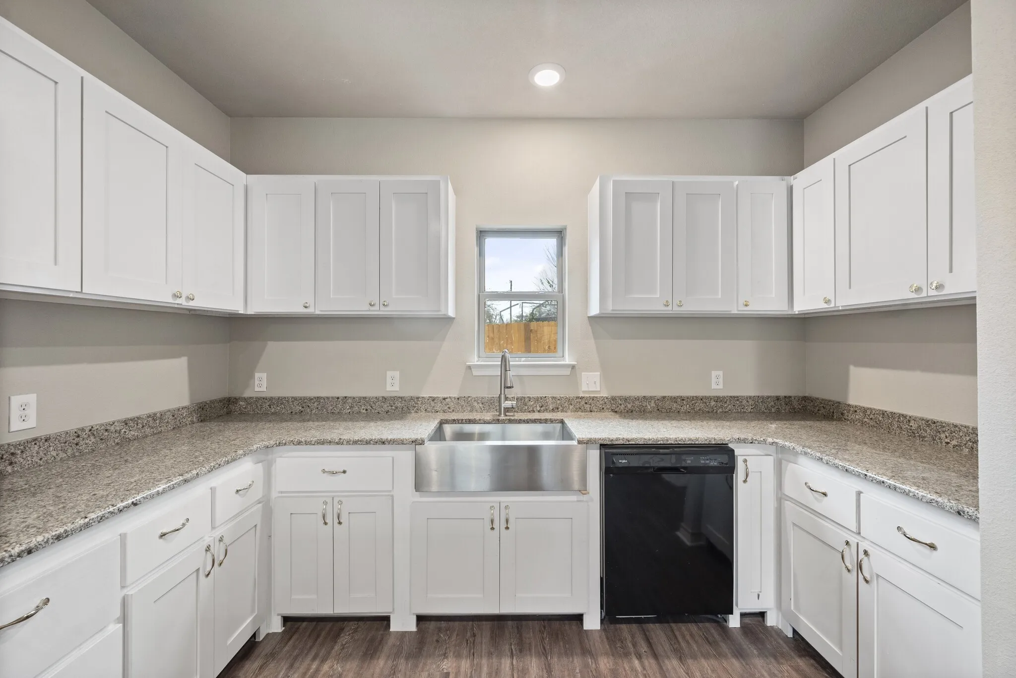 Kitchen featuring white cabinetry, black dishwasher, light stone countertops, dark wood-style floors, and recessed lighting
