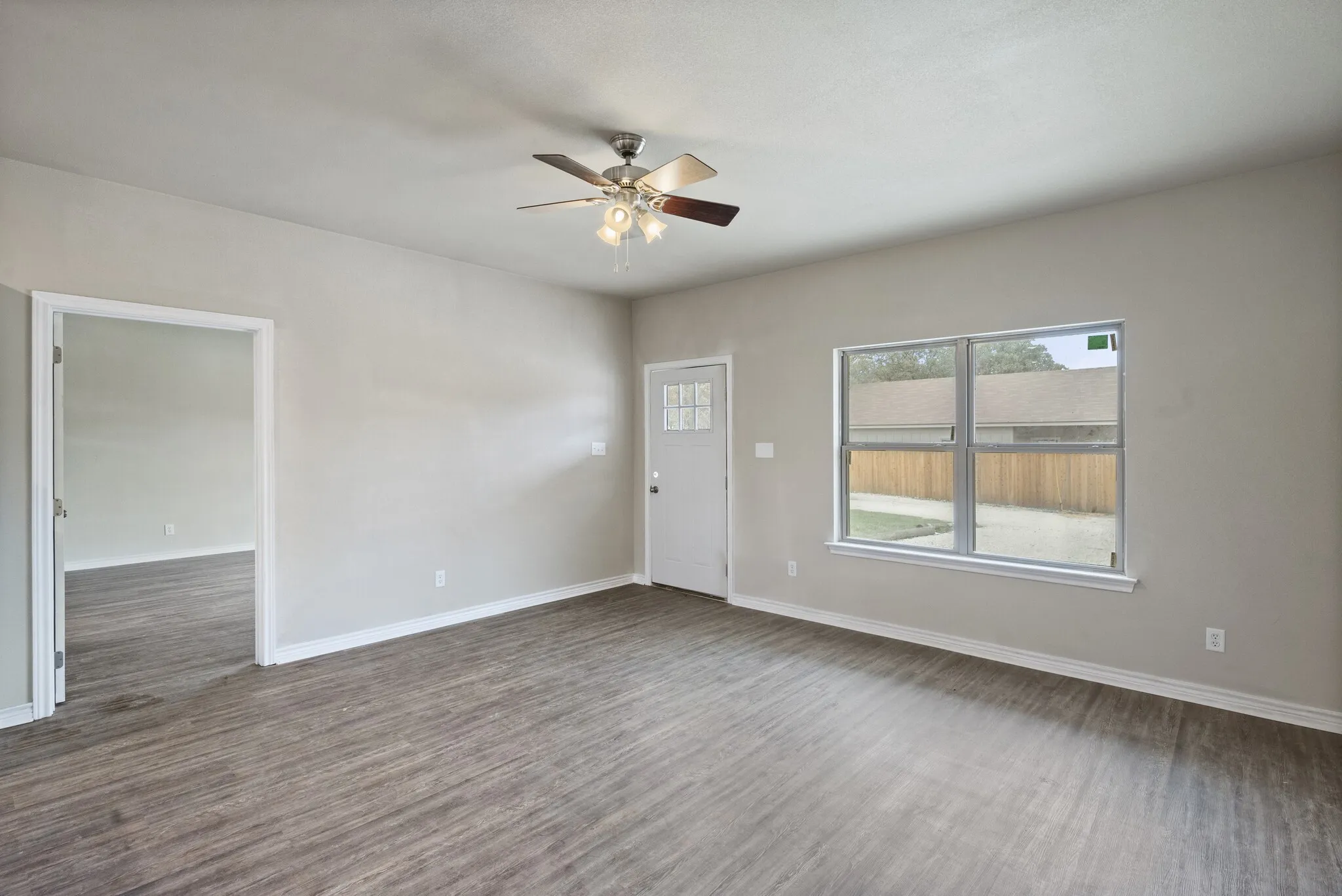 Unfurnished room with ceiling fan and dark wood-style floors