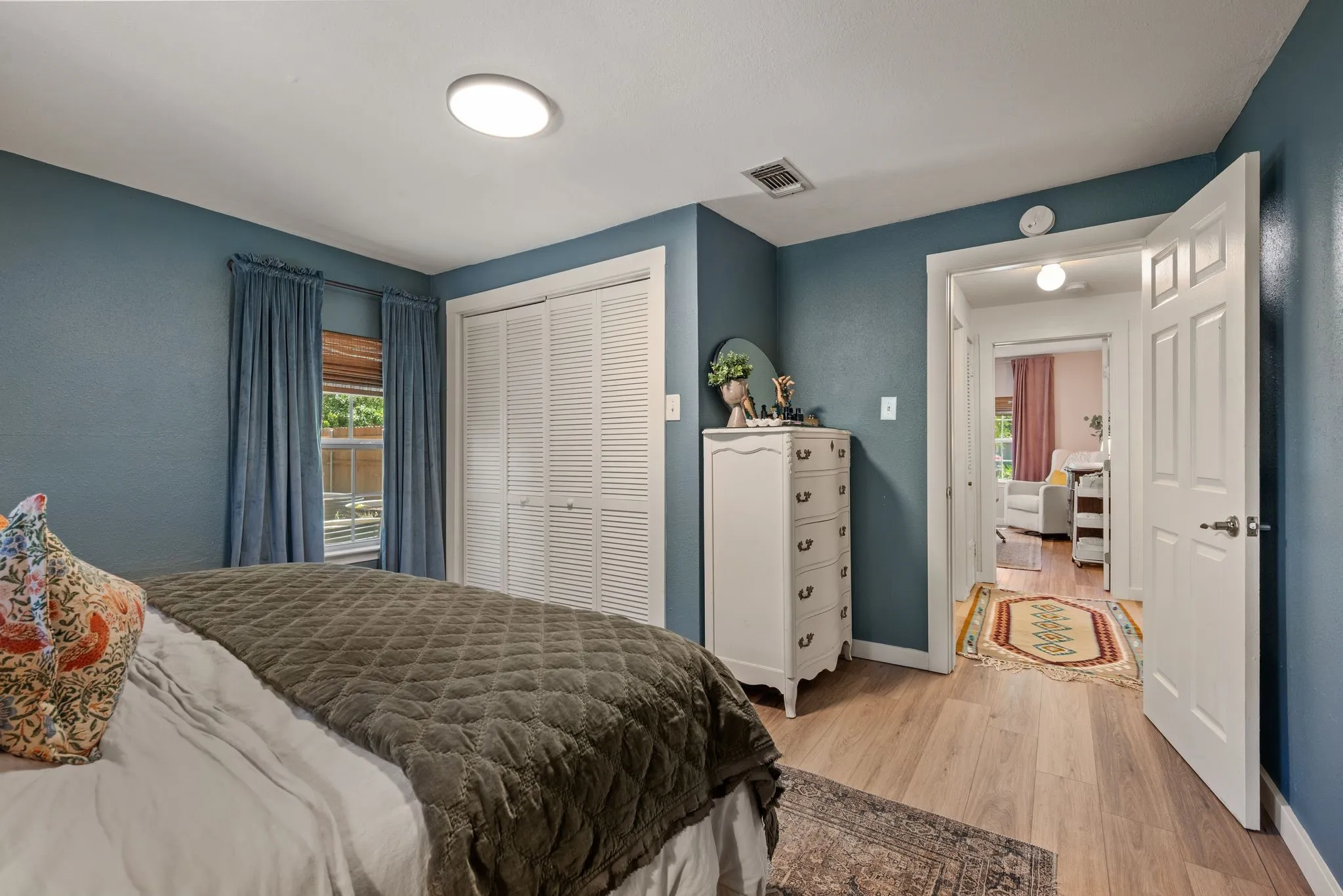 Bedroom featuring light wood-style floors and a closet