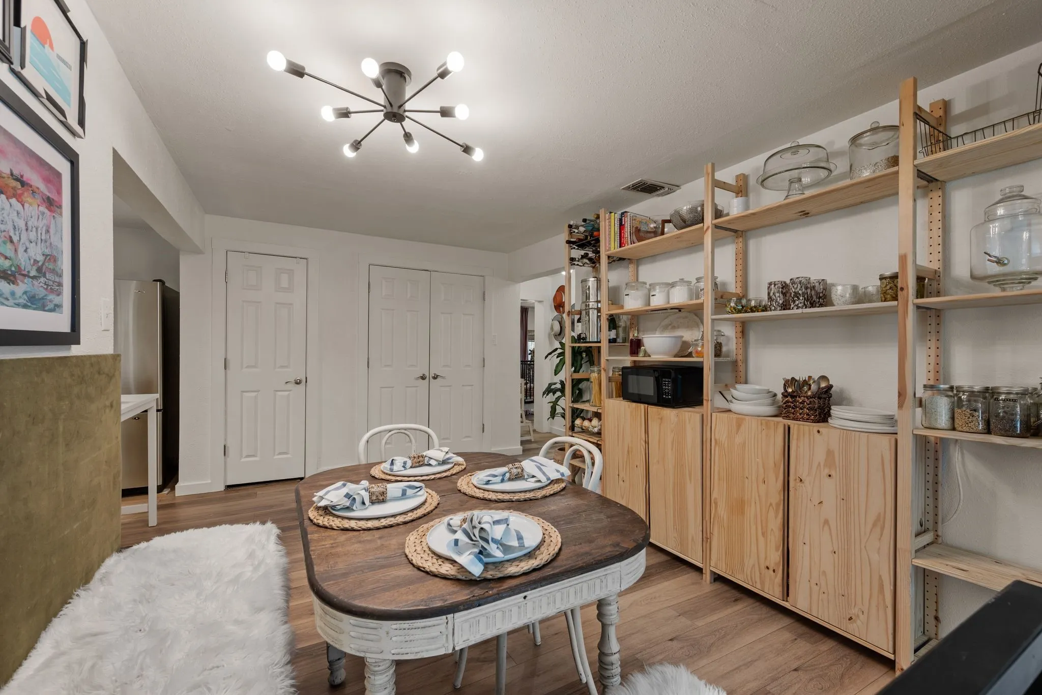 Dining space with a chandelier and light wood-style flooring