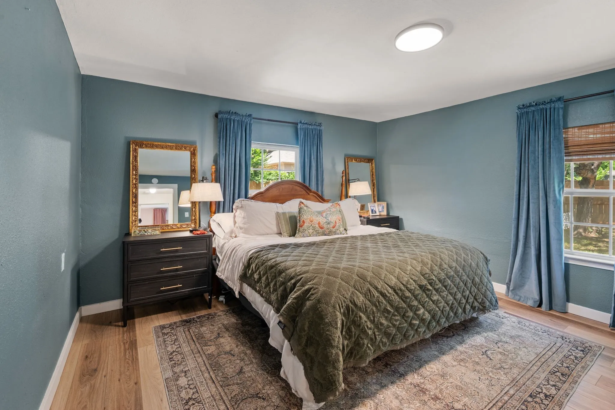 Bedroom with wood finished floors and baseboards