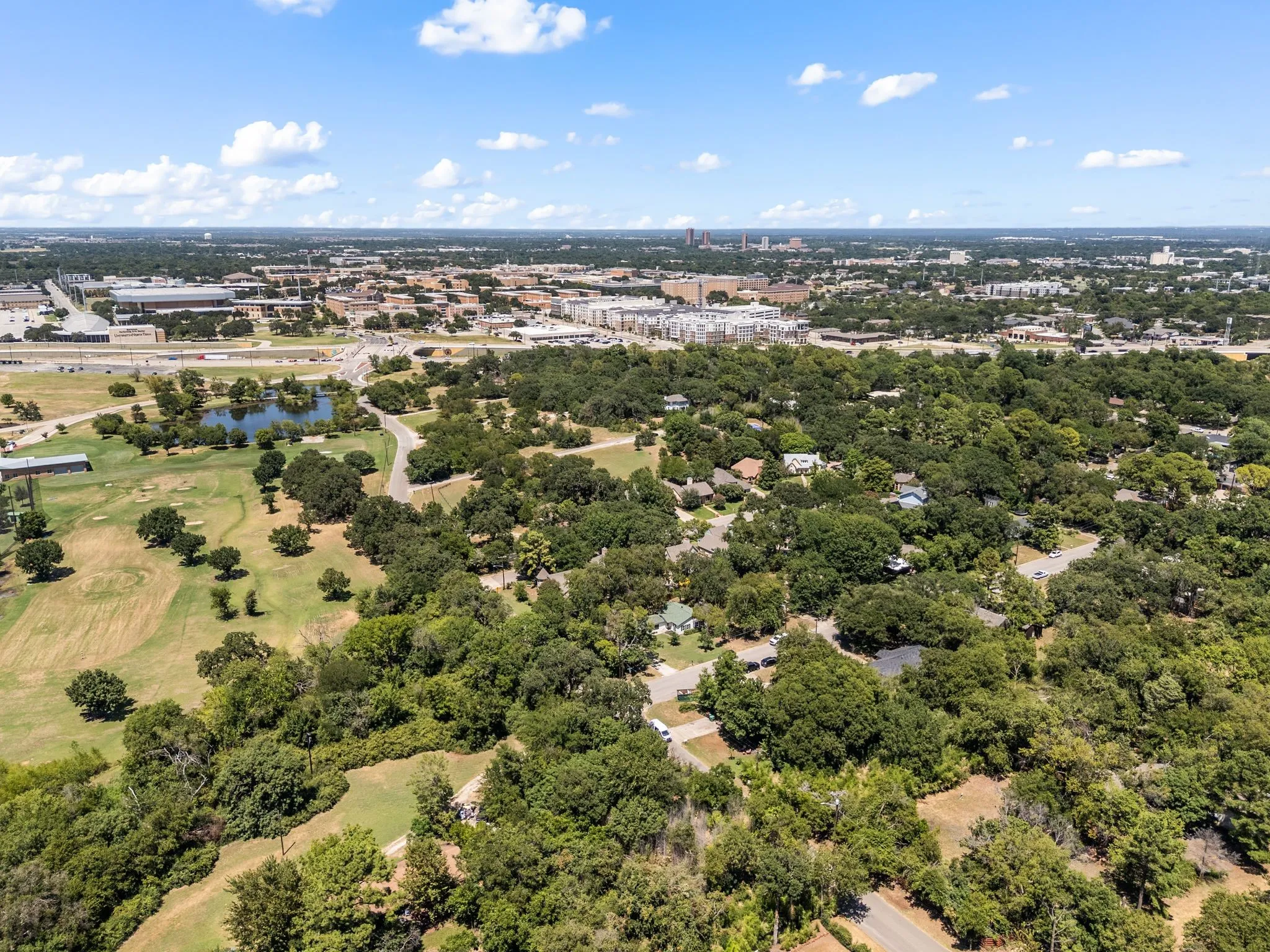 Bird's eye view of a nearby body of water and a golf club