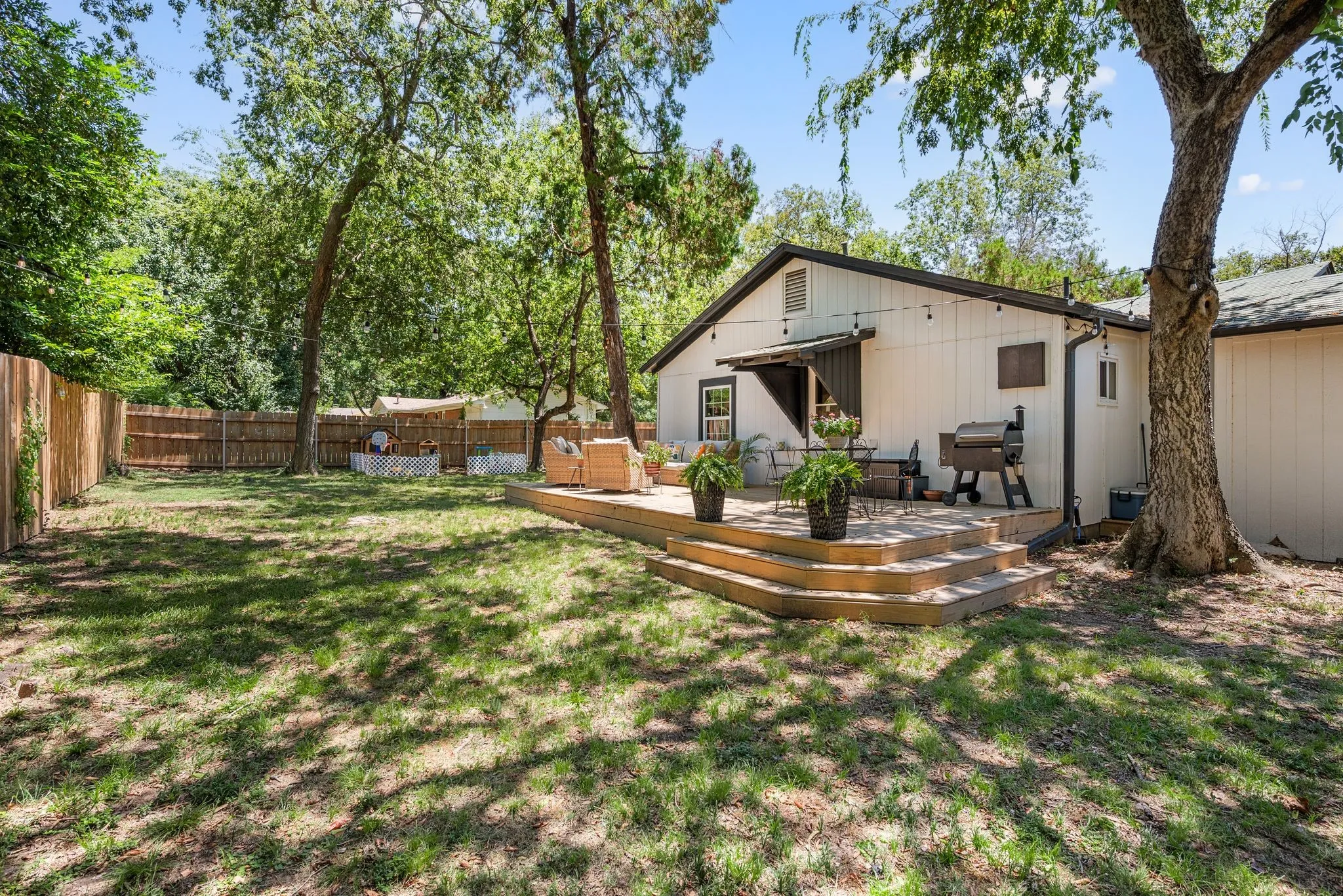 Back of house featuring a fenced backyard and a wooden deck