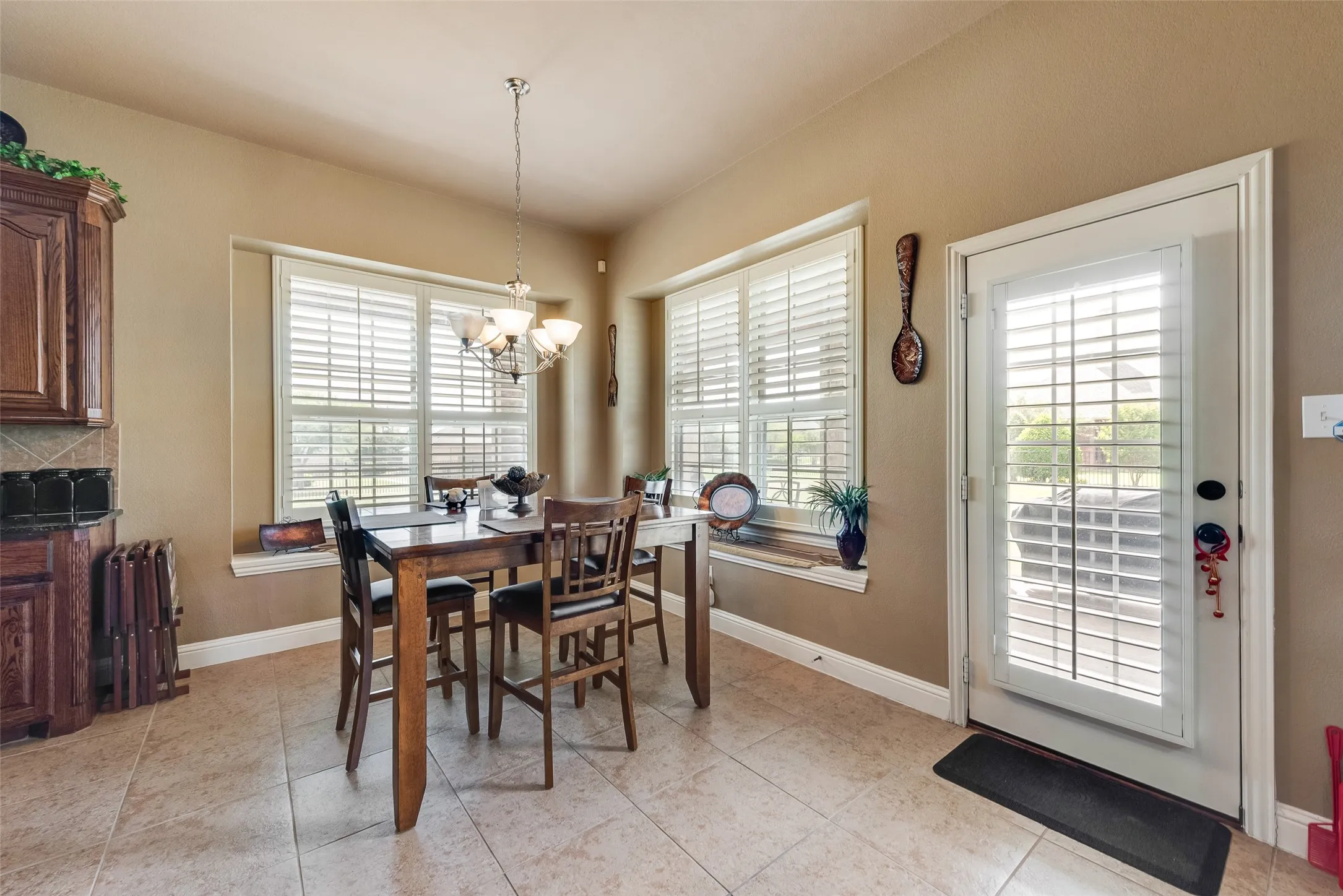Dining space with a chandelier and light tile patterned flooring