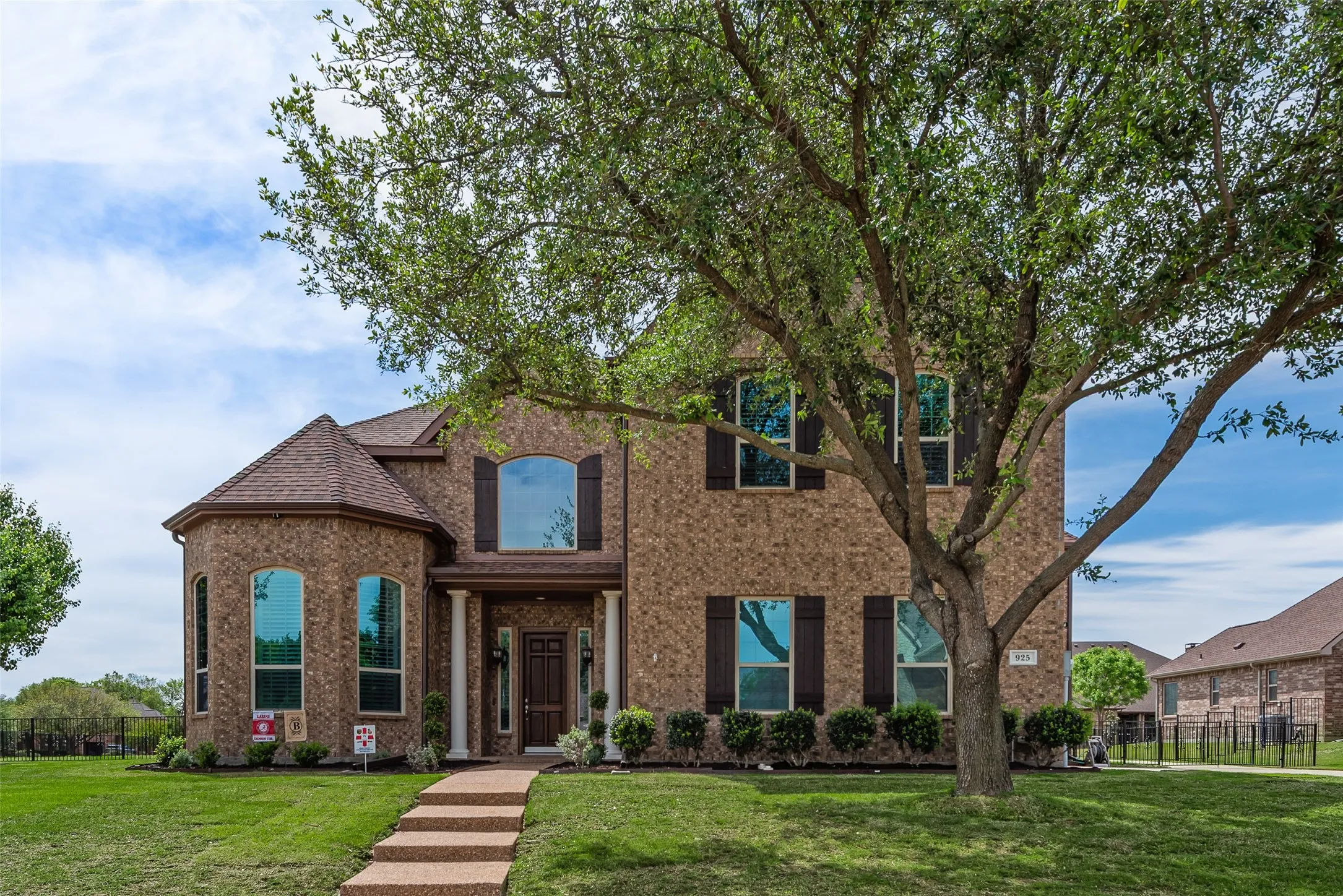 View of front facade featuring brick siding and roof with shingles