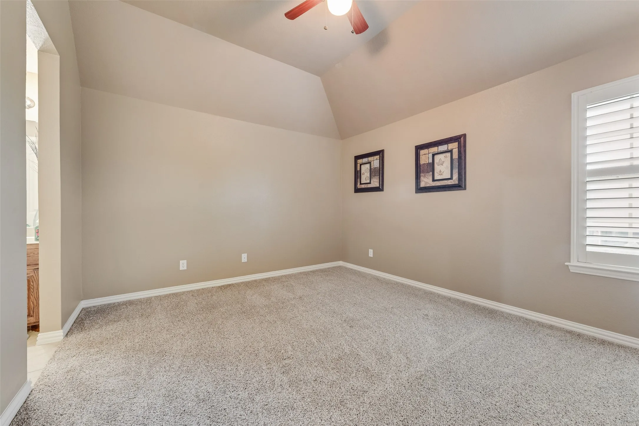 Unfurnished room with light carpet, a ceiling fan, and lofted ceiling