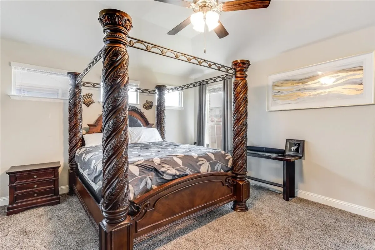 Wall-to-wall carpeting, recessed windows, vaulted ceiling, and a ceiling fan with integrated lighting