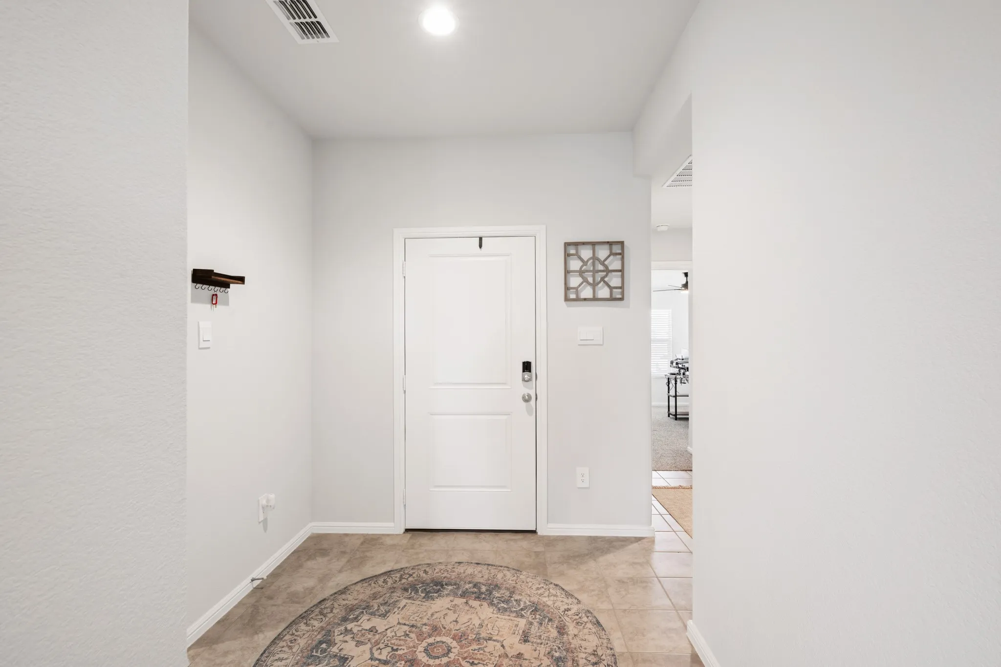 Entryway with baseboards and light tile patterned floors