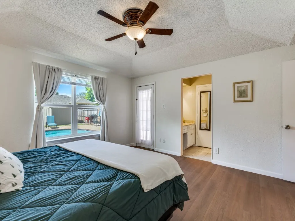 The primary suite windows overlook the patio. You'll love the direct access to the patio and pool!