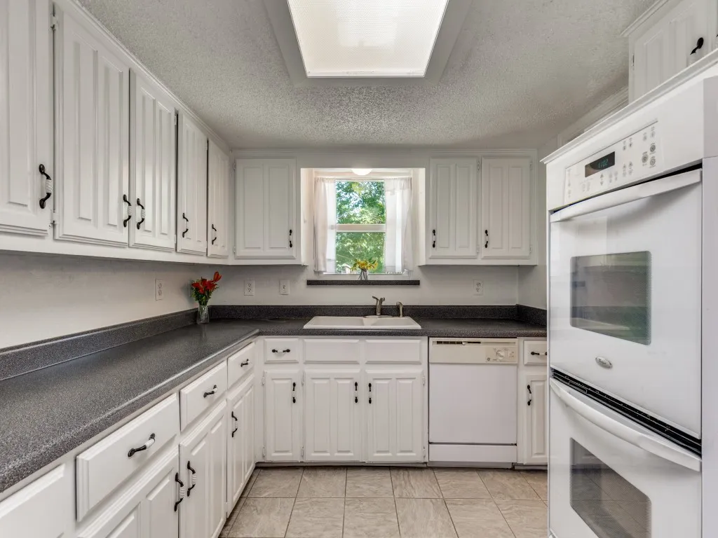 A perfect-sized kitchen featuring a double-oven and plenty of cabinet and counter space. Refrigerator conveys with an acceptable offer.