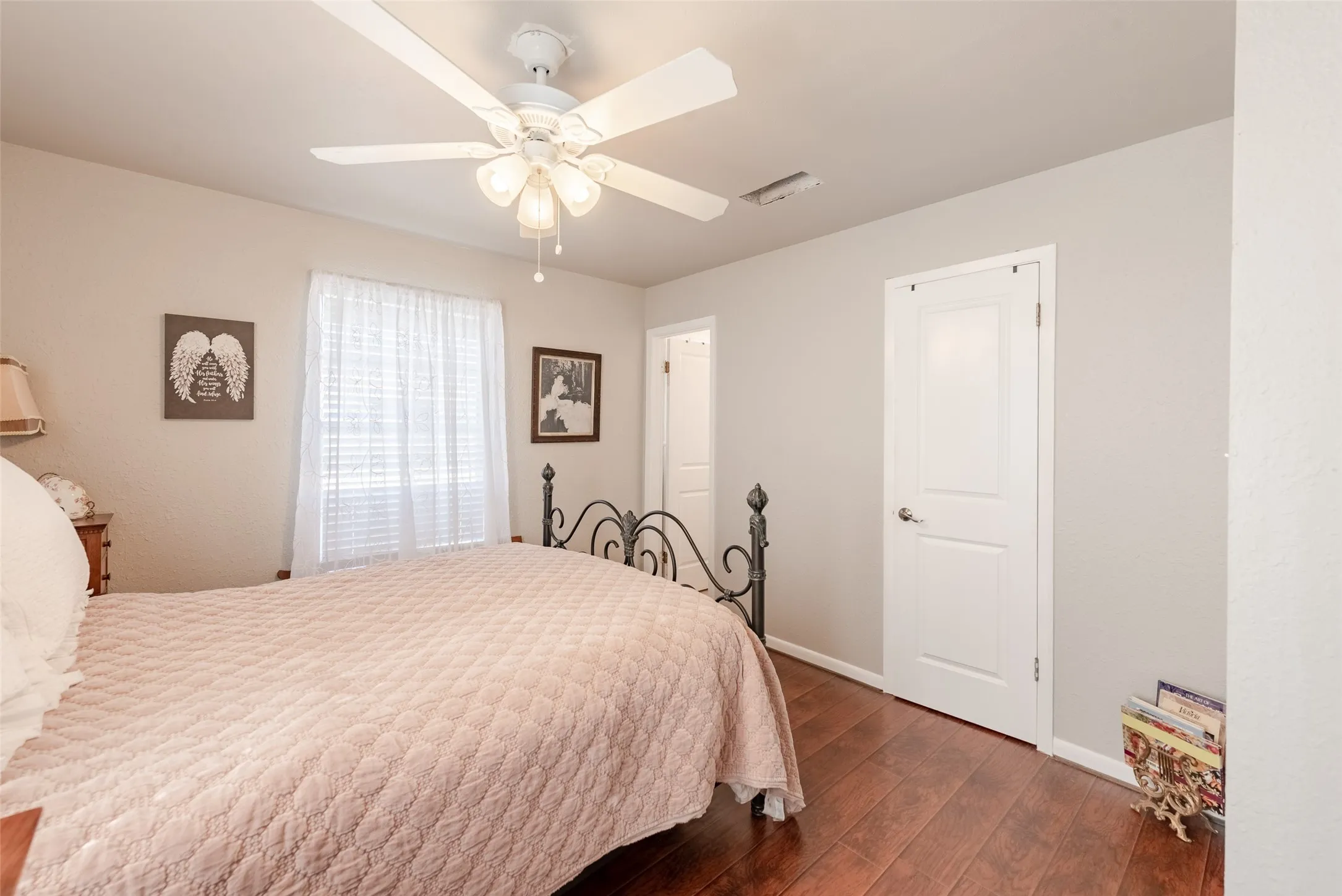 Bedroom with ceiling fan and dark wood-type flooring