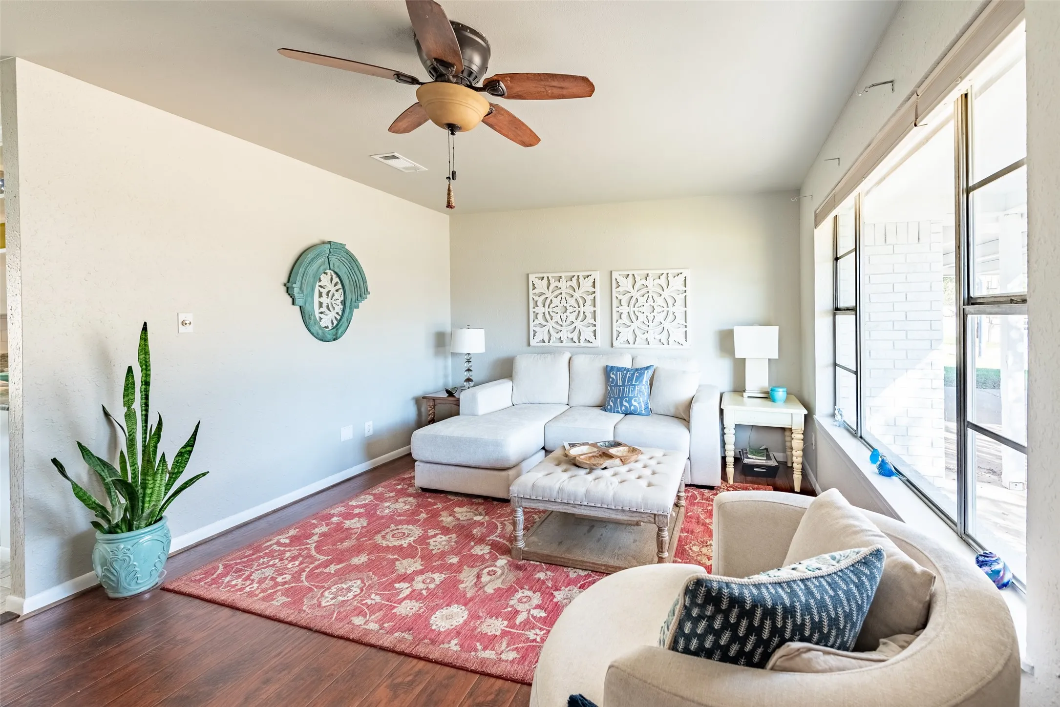 Living room featuring ceiling fan and hardwood / wood-style floors