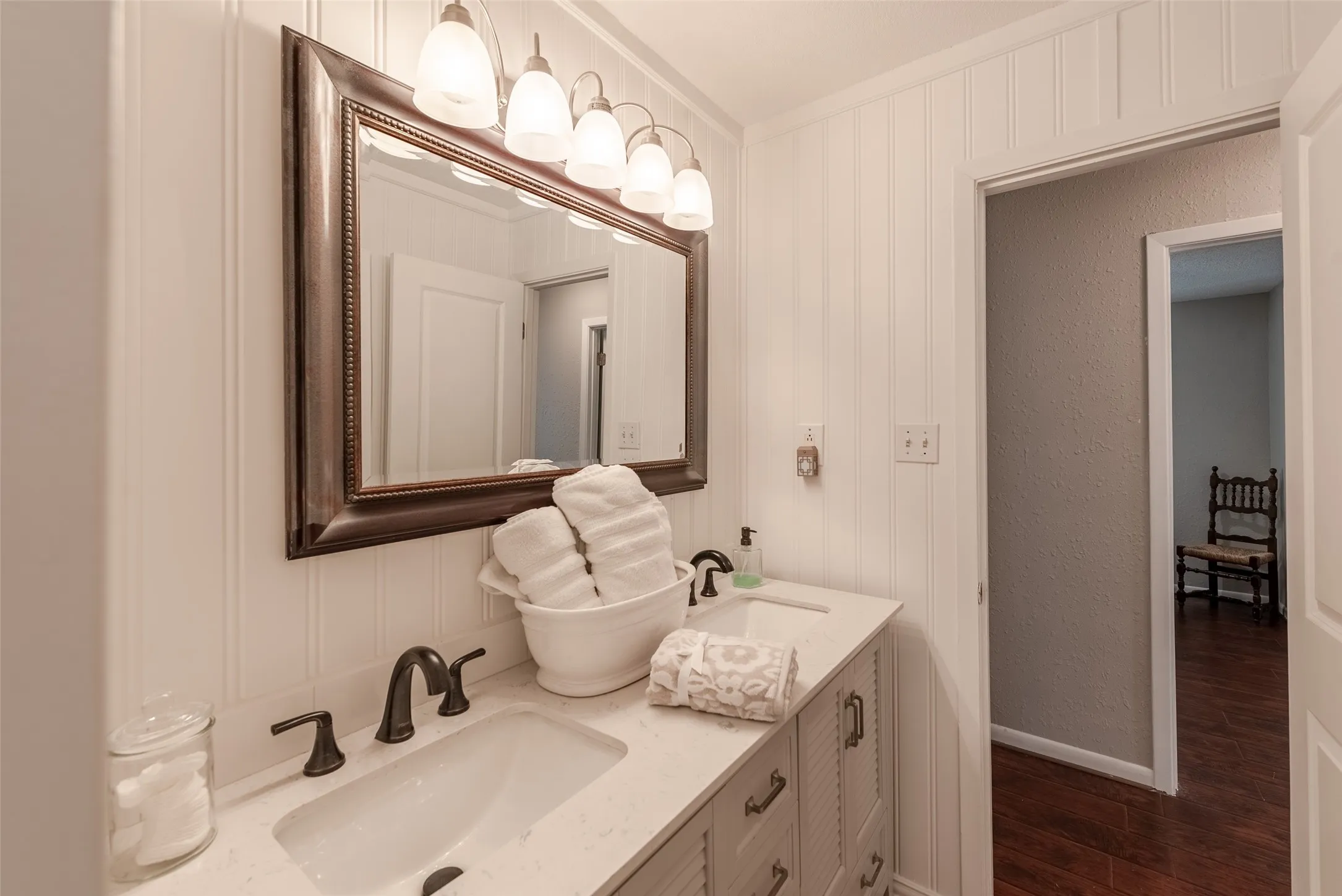 Bathroom with hardwood / wood-style floors, vanity, and crown molding