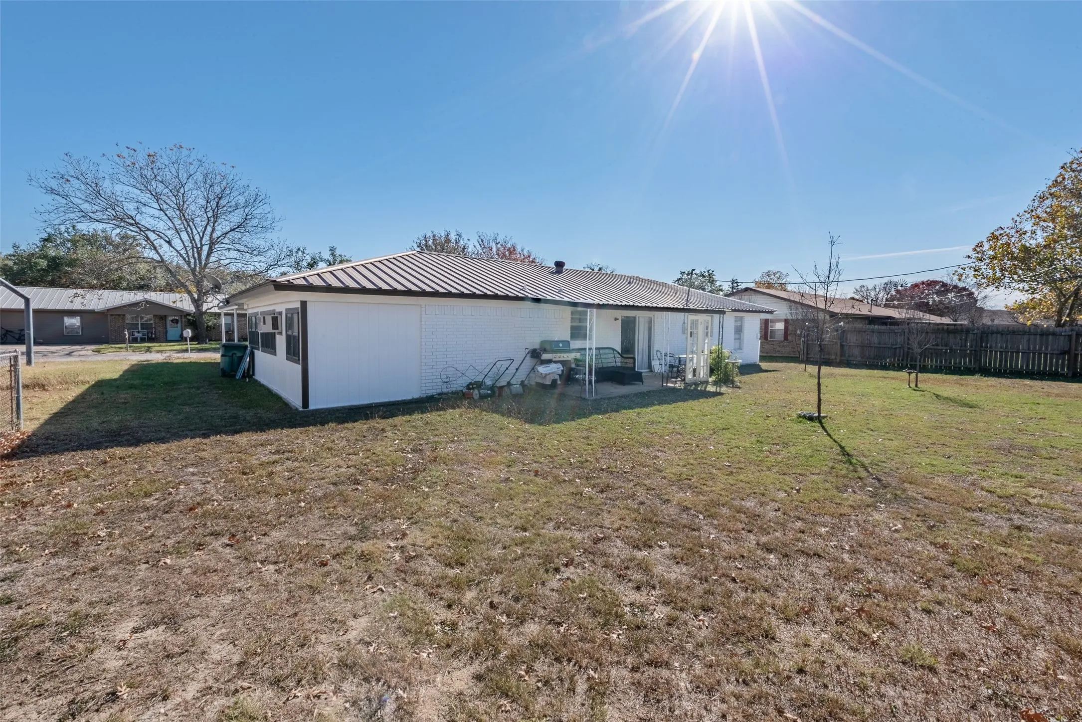 Back of property featuring a yard